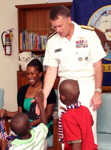 A resident of the Grand Bahama Children’s Home greets Adm. James A. Winnefeld, Jr., NORAD and USNORTHCOM commander, on arrival to the home June 30. The commander visited the home with U.S. Ambassador to The Bahamas Nicole A. Avant to present $2,500 worth of clothing, footwear, bedding, games and art supplies to the home on behalf of USNORTHCOM’s Humanitarian Assistance Program. 

