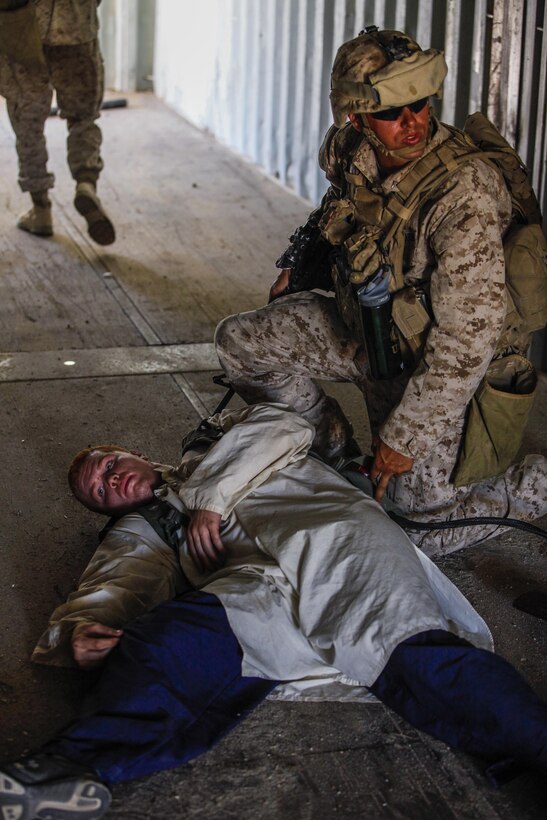 A Marine rifleman, right, from 3rd Battalion, 1st Marine Regiment of Marine Corps Base Camp Pendleton, Calif., searches a Marine roleplayer from the Tactical Training Exercise Control Group, left, after he was “killed” during a long-range raid training exercise in the desert southeast of Marine Corps Air Station Yuma, Ariz., June 3. The job of the roleplayer is to provide realistic simulation and opposition for Marines during training exercises.