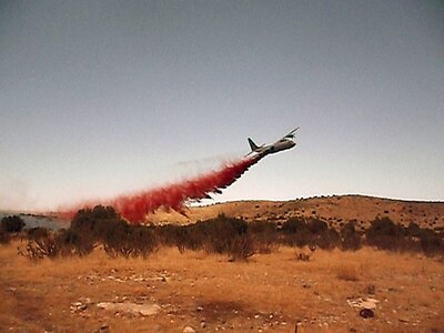 A view from ground firefighting crews as MAFFS 6 drops fire retardant to aid in the control of the Donaldson fire. When full, the tanks being loaded hold 3,000 gallons of fire retardant. Established by Congress in the early '70s as a wildland fire protection program, MAFFS is a joint program with the Air National Guard, Air Force Reserve, and the U.S. Forest Service. 

