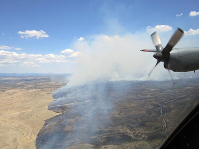 Aerial view from the crew of a Modular Airborne Fire Fighting System-equipped C-130 aircraft as they return from dropping a load of fire retardant on the Donson wildfire in New Mexico. 

