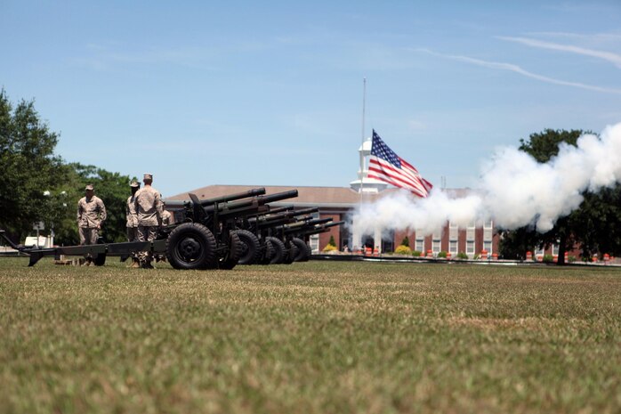 Golf Battery 2nd Battatlion 10th Marines Regiment cannoneer Marines fire blank rounds from 155 mm Howitzer used during a Memorial Day 21 gun salute at the parade deck May 27. More than two dozen residents and veterans attended the ceremony. Teams of three cannonier Marines fired blank rounds from four Howitzers. Blank rounds are used during ceremonies for their visual effect and for safety. The garrison flag flew at half-mast during the ceremony.
