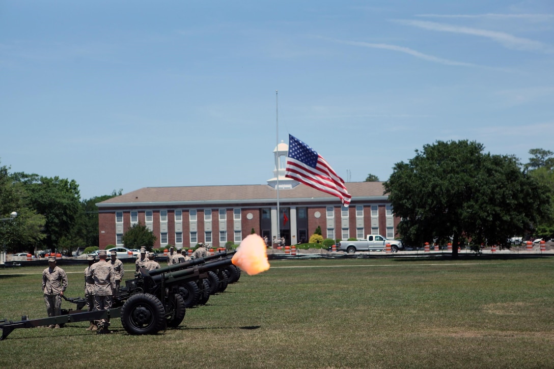 Golf Battery 2nd Battalion 10th Marines Regiment cannoneer Marines fire blank rounds from 155 mm Howitzer used during a Memorial Day 21 gun salute at the parade deck May 27. More than two dozen residents and veterans attended the ceremony. Teams of three cannoneer Marines fired blank rounds from four Howitzers. Blank rounds are used during ceremonies for their visual effect and for safety. The garrison flag flew at half-mast during the ceremony.