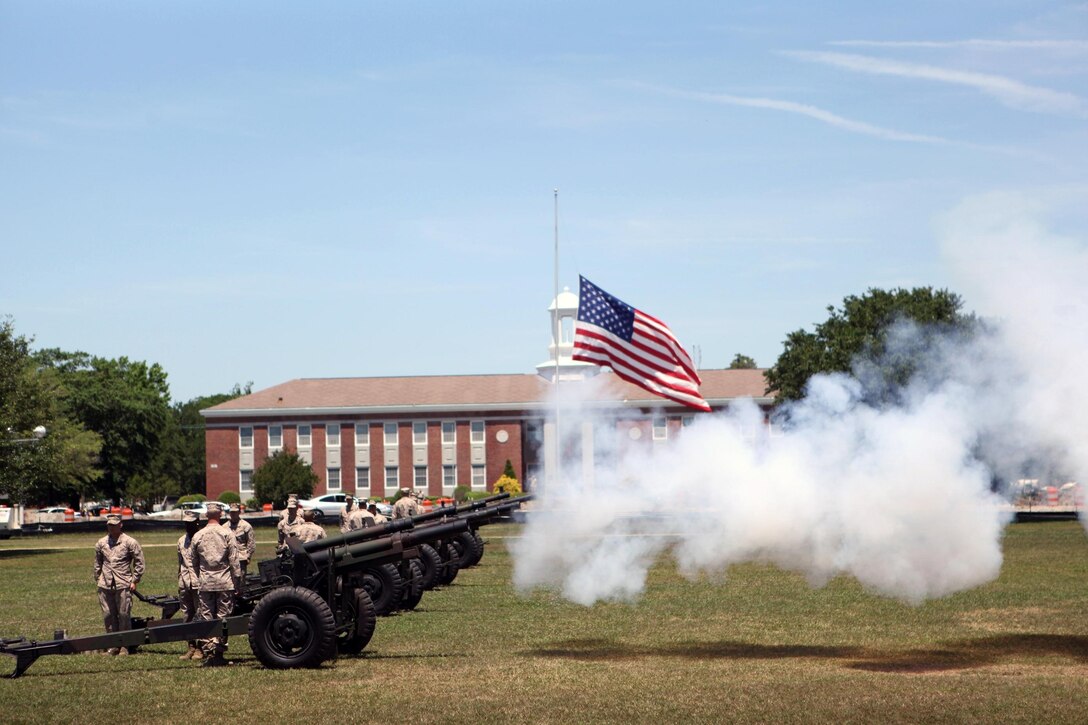 Golf Battery 2nd Battalion 10th Marines Regiment cannoneer Marines fire blank rounds from 155 mm Howitzer used during a Memorial Day 21 gun salute at the parade deck May 27. More than two dozen residents and veterans attended the ceremony. Teams of three cannoneer Marines fired blank rounds from four Howitzers. Blank rounds are used during ceremonies for their visual effect and for safety. The garrison flag flew at half-mast during the ceremony.