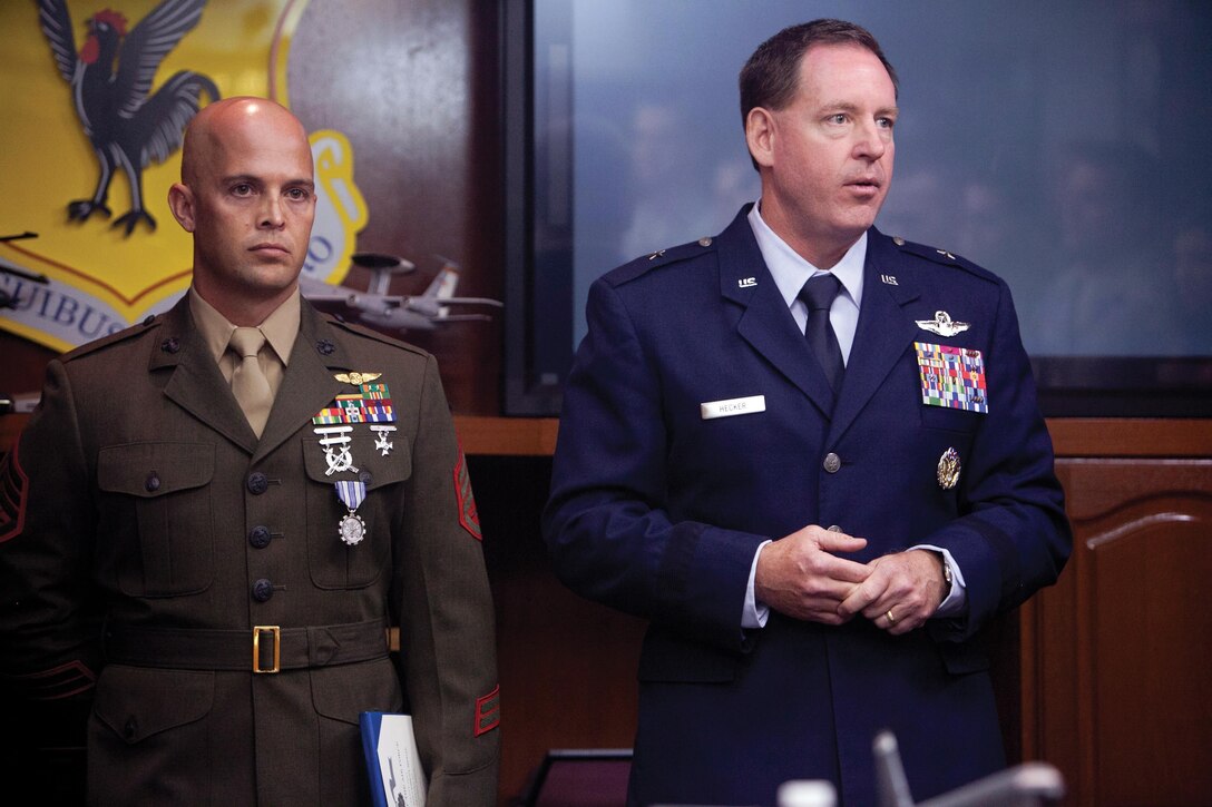 U.S. Air Force Brig. Gen. James B. Hecker, right, addresses the audience after awarding the Air Force Achievement Medal to Staff Sgt. Benjamin G. Whalen July 8 at the 18th Wing Headquarters on Kadena Air Base. Whalen was awarded for rescuing a 14-year-old boy at the Hagerstrom Pool on the air base. Hecker is the commanding general of the 18th Wing. Whalen is the communications navigations staff noncommissioned officer in charge with Marine Aerial Refueler Transport Squadron 152, Marine Aircraft Group 36, 1st Marine Aircraft Wing, III Marine Expeditionary Force. Photo by Cpl. Alyssa N. Gunton