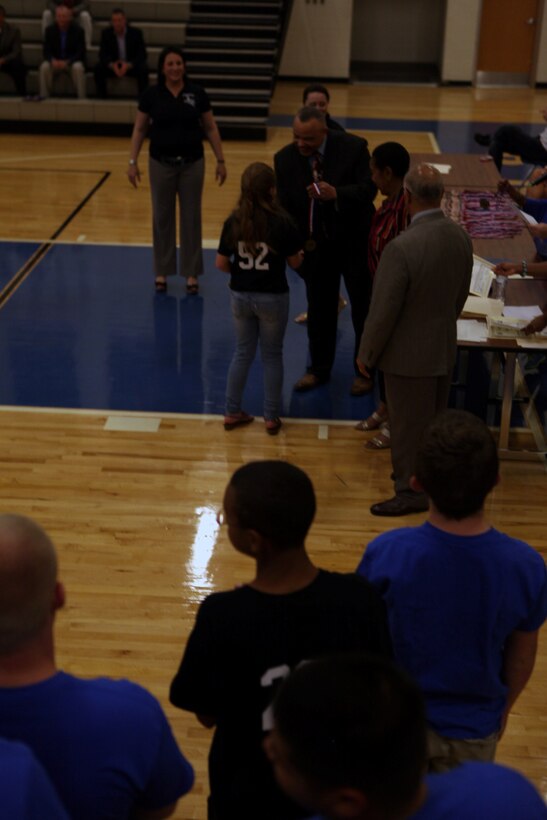 Hoops-N-Dreams participants receive awards and medals during the programs' recognition banquet at Brewster Middle School gymnasium aboard Marine Corps Base Camp Lejeune, May 17.