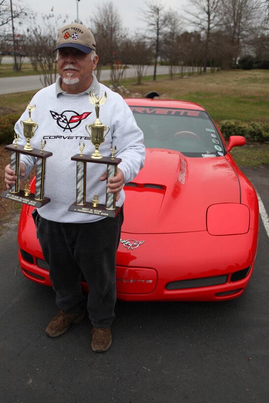 Jim Williams, a car show participant who won classic auto and best in show, holds his trophies in front of his 2001 Z06 Corvetter during a V Foundation car show, March 23. The car show raised more than $1,000 for Duke Children's Hopsital pediatric cancer research.