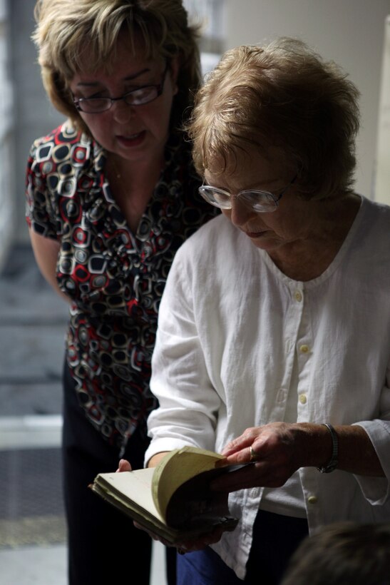 Melanie Sheldon and Charlotte Dexter, children of former Camp Lejeune land owners, look through record books while visiting the public works office aboard Marine Corps Base Camp Lejeune, June 27. Five children of former land owners and their families have compiled photos and information about the former land owners and their properties since 2005. The women visited the public works office records vault to research the land's history more and share information with Harold Napier, a realty specialist with Marine Corps Installations East-Marine Corps Base Camp Lejeune Installation Development Division. A reunion for former Camp Lejeune land owner's and their descendants is scheduled for the first Sunday in October at the Staff Noncommissioned Officer's Club aboard base. For more information about the land owners, visit www.marinebasehomes.smugmug.com.