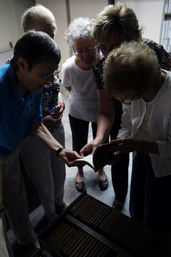 Catherine Aman, Mary Mobley Baggett, Jean Gillette, Melanie Sheldon and Charlotte Dexter, children of former Camp Lejeune land owners, look through record books while visiting the public works office aboard Marine Corps Base Camp Lejeune, June 27. The women and their families have compiled photos and information about the former land owners and their properties since 2005. The women visited the public works office records vault to research the land's history more and share information with Harold Napier, a realty specialist with Marine Corps Installations East-Marine Corps Base Camp Lejeune Installation Development Division. A reunion for former Camp Lejeune land owner's and their descendants is scheduled for the first Sunday in October at the Staff Noncommissioned Officer's Club aboard base. For more information about the land owners, visit www.marinebasehomes.smugmug.com.