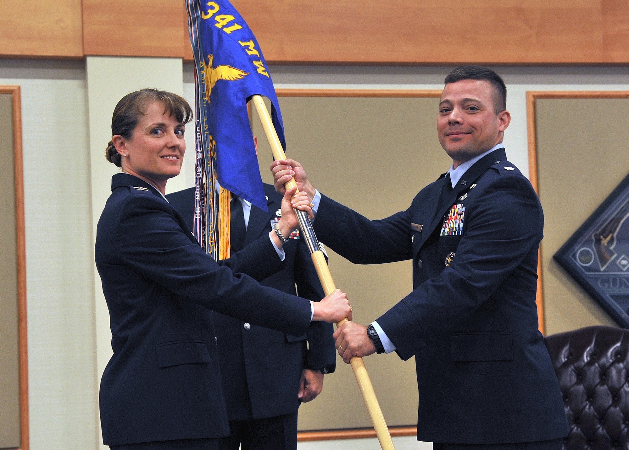 Lt. Col. Monte Harner, right, accepts command of the 341st Mission Support Group from Col. Marné Deranger, 341st Missile Wing vice commander, at the Grizzly Bend on July 9. Col. Angela Stout, was the relinquishing commander of the 341st MSG. (U.S. Air Force photo/ John Turner)