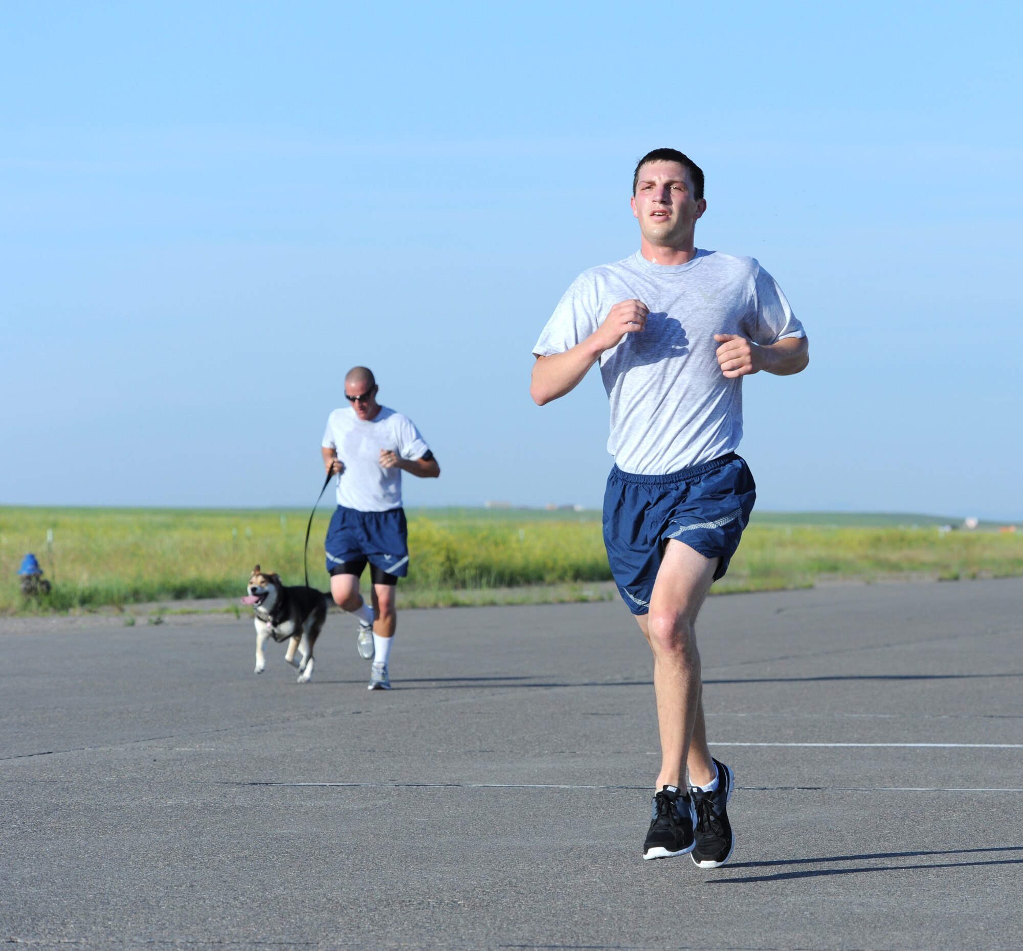 Senior Airman Peter Bilyk, 341st Comptroller Squadron financial management analyst, quickens his pace during a 5K on the Malmstrom flightline July 3. Hundreds of Airmen participated in the first wing fun run since 2011. (U.S. Air Force photo/Senior Airman Katrina Heikkinen)