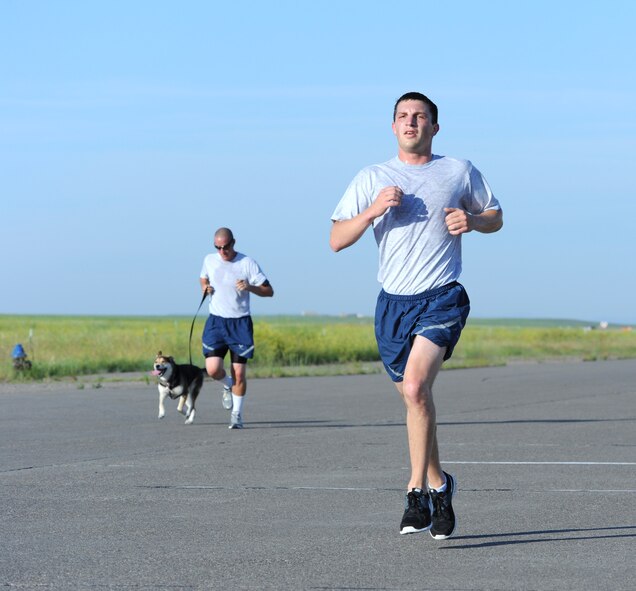 Senior Airman Peter Bilyk, 341st Comptroller Squadron financial management analyst, quickens his pace during a 5K on the Malmstrom flightline July 3. Hundreds of Airmen participated in the first wing fun run since 2011. (U.S. Air Force photo/Senior Airman Katrina Heikkinen)