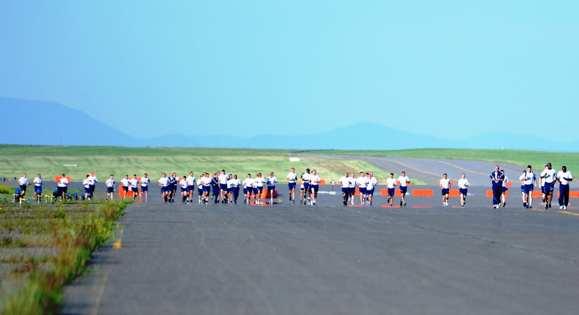 Dozens of Team Malmstrom members round the half-way corner of a 5K and 1.5-mile run during a wing fun run on July 3. Two more runs are scheduled for Aug. 23 and Sept. 20 at 7 a.m. at the base flight line. (U.S. Air Force photo/Senior Airman Katrina Heikkinen)