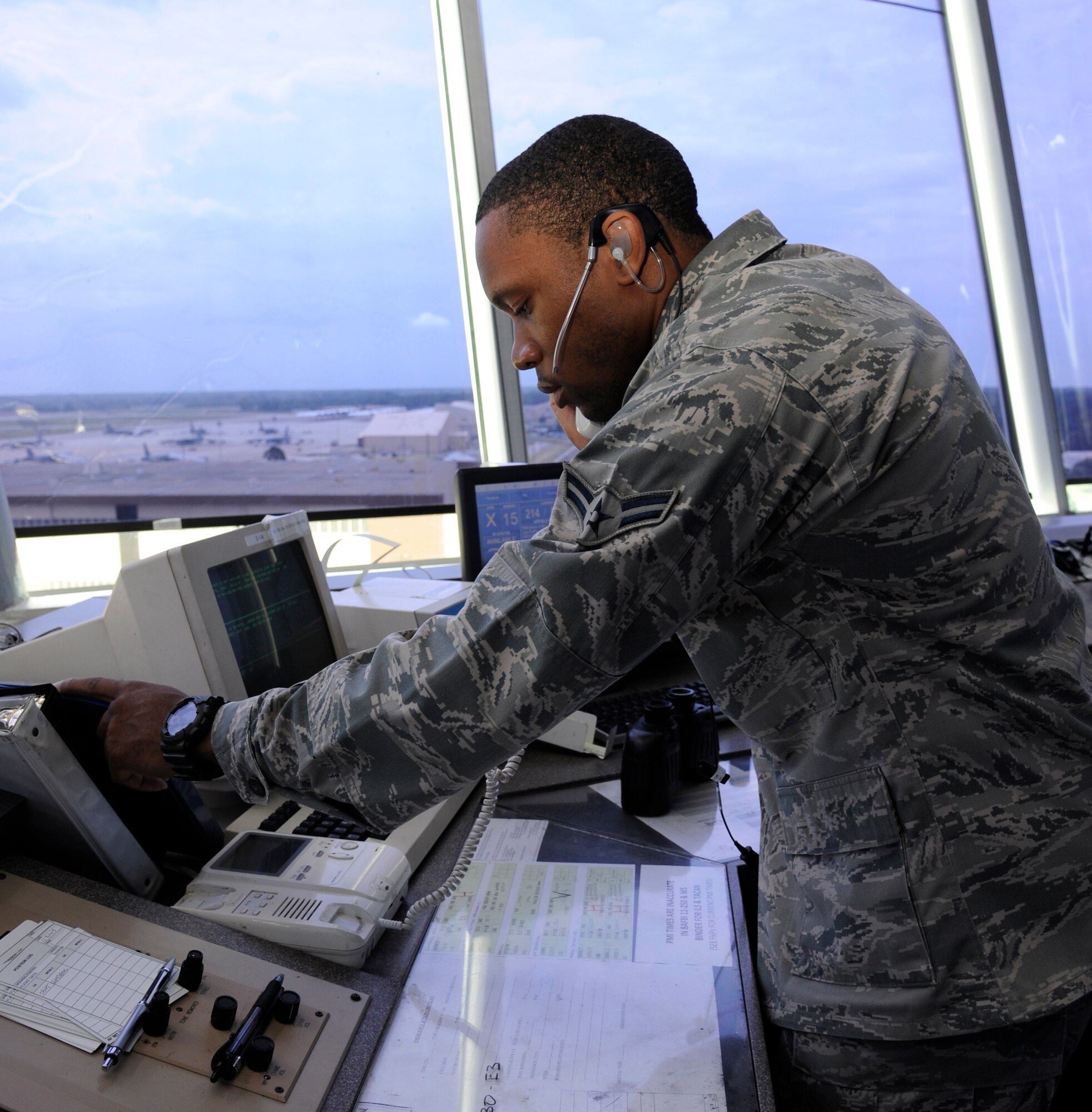 Airman 1st Class John Porter, 2nd Operations Support Squadron air traffic controller, reaches for an entry authorization list on Barksdale Air Force Base, La., July 11, 2013. The access list is used to inform air traffic controllers on who is authorized to enter the control tower. (U.S. Air Force photo/Airman 1st Class Andrew Moua)
