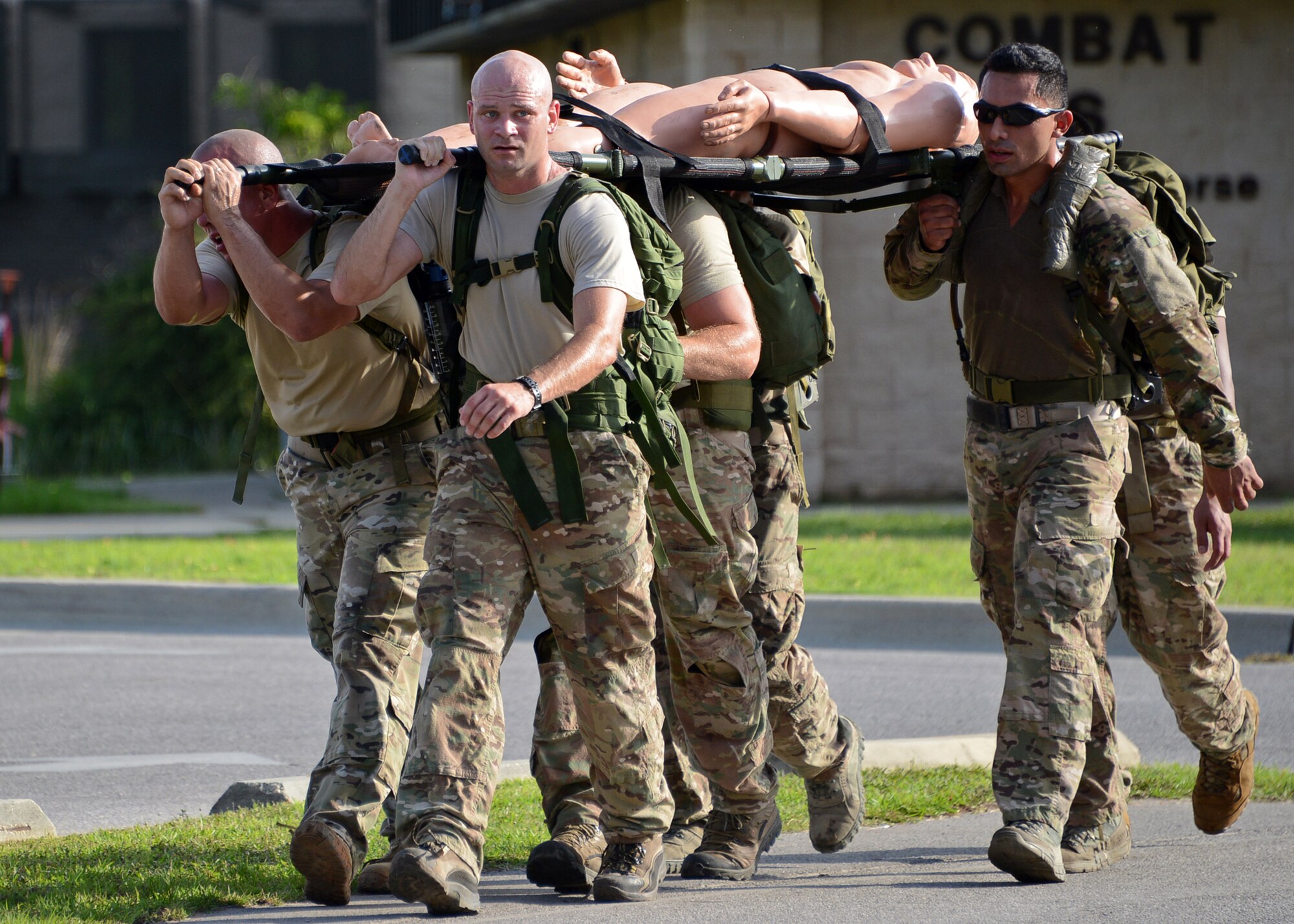 Members of the 23rd Special Tactics Squadron litter-carry a medical mannequin as part of a Monster Mash at Hurlburt Field, Fla., June 28, 2013. As part of their Wingman Day activities, the members of the 23rd STS worked in small teams to compete in the warrior challenge. (U.S. Air Force photo by Capt. Belena S. Marquez/Released)