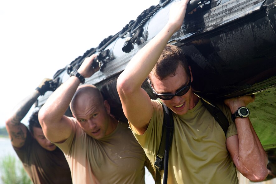 A team of Airmen assigned to the 23rd Special Tactics Squadron help carry a zodiac to the finish line during a Monster Mash June 28, 2013 at Hurlburt Field, Fla. Eight teams of six Airmen competed against each other for time. (U.S. Air Force photo by Staff Sgt. Melanie Holochwost)