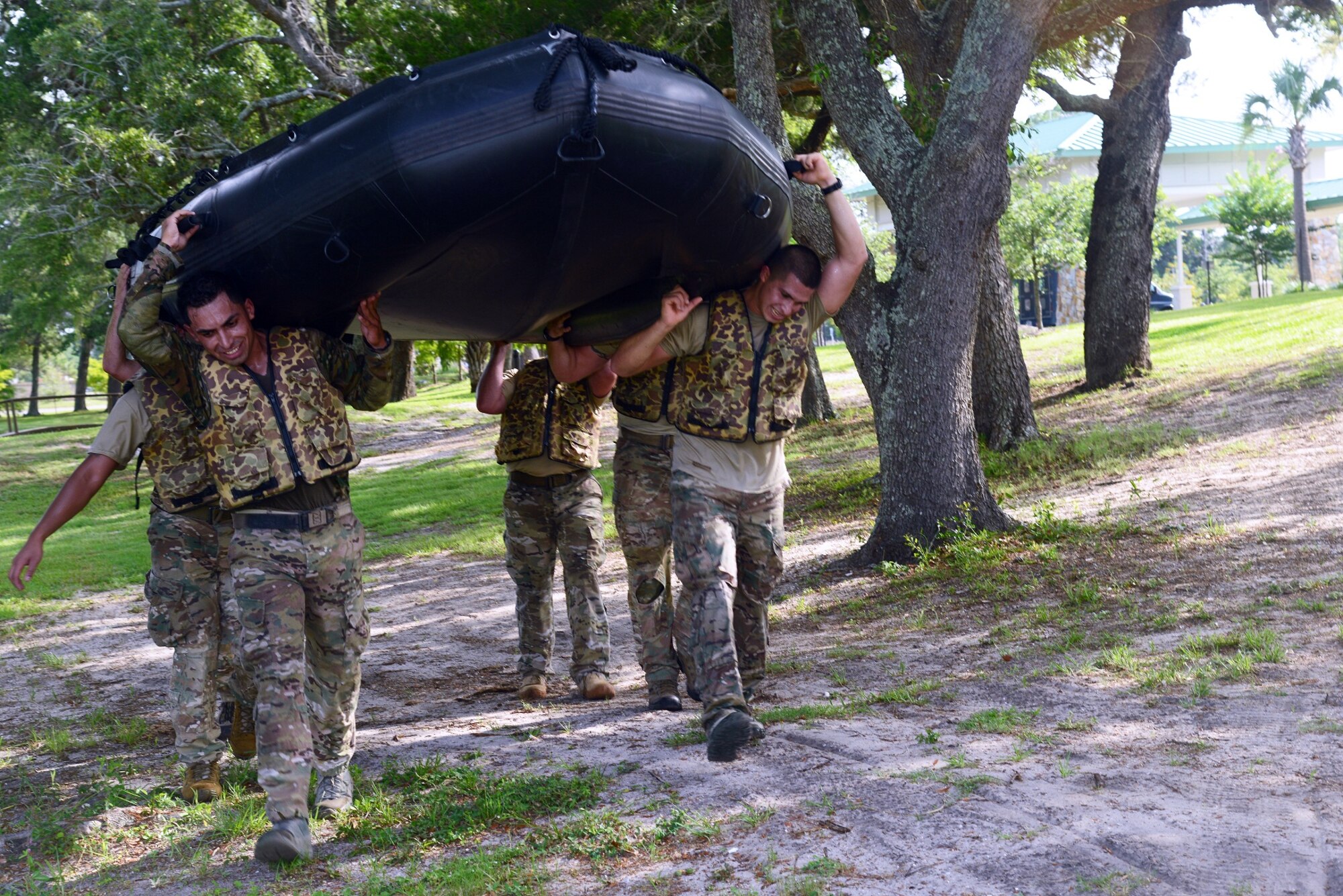 A team of Air Commandos assigned to the 23rd Special Tactics Squadron carry a zodiac to the water during a Monster Mash June 28, 2013 at Hurlburt Field, Fla. A Monster Mash is a competition which combines physical and mental challenges. (U.S. Air Force photo by Staff Sgt. Melanie Holochwost)