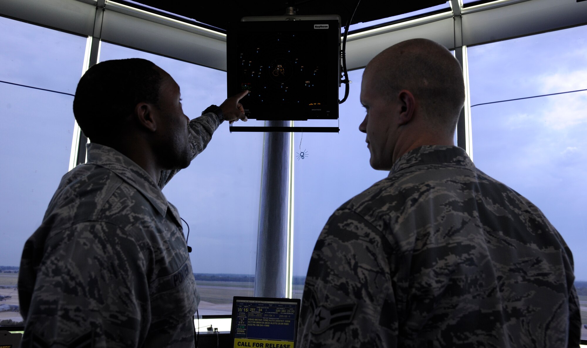 Airmen 1st Class John Porter and Dustin Reinhart, 2nd Operations Support Squadron air traffic controllers, discuss radar information, on Barksdale Air Force Base, La., July 11, 2013. Air traffic control Airmen use the radar information to keep track of weather patterns and other aircraft in the sky. (U.S. Air Force photo/Airman 1st Class Andrew Moua)