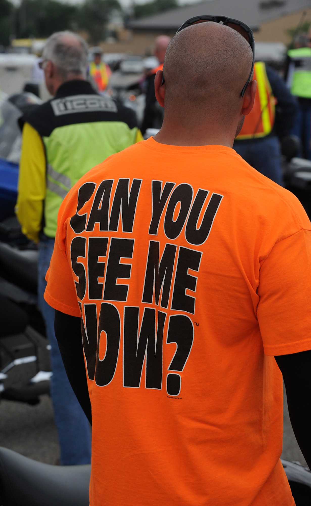An event participant sports a bright orange  “Can You See Me Now” shirt at the ‘See Me, Save Me’ campaign ride at Hill Air Force Base, Utah, July 11. The goal of the ride was to motivate motorists to take a second look for motorcycles on the road. (U.S. Air Force photo by Alex R. Lloyd/Released)