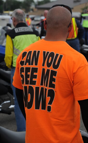An event participant sports a bright orange  “Can You See Me Now” shirt at the ‘See Me, Save Me’ campaign ride at Hill Air Force Base, Utah, July 11. The goal of the ride was to motivate motorists to take a second look for motorcycles on the road. (U.S. Air Force photo by Alex R. Lloyd/Released)