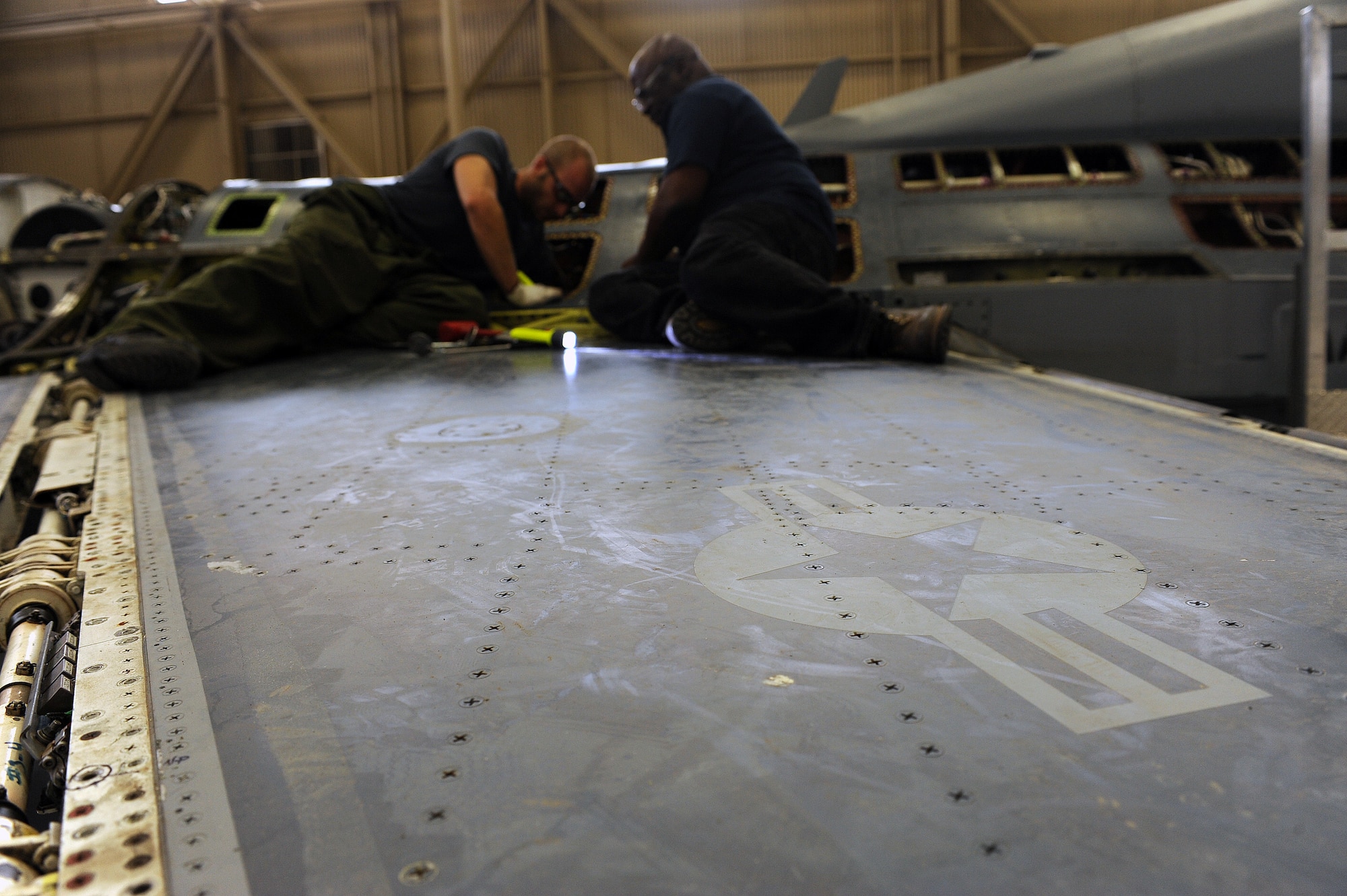 U.S. Air Force civilians Lonnie Thomas and Andrew Bakios, 567th Aerospace Maintenance and Regeneration Squadron perform maintenance on one of six fuel tanks on the QF-16 at the 309th Aerospace Maintenance and Regeneration Group at Davis-Monthan Air Force Base, Ariz., July 9, 2013. The “Q” designation in the aircraft’s name signifies that the aircraft is a drone. (U.S. Air Force photo by Senior Airman Christine Griffiths/Released)