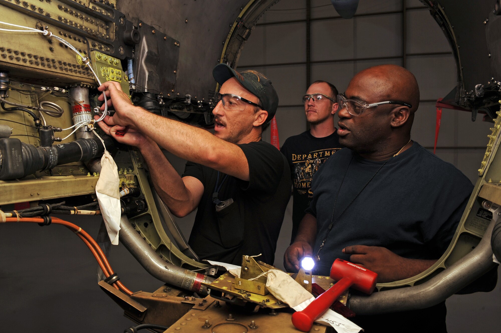 U.S. Air Force civilians Robert Bliven and Andrew Bakios, 567th Aerospace Maintenance and Regeneration Squadron perform maintenance on the first QF-16 being regenerated at the 309th Aerospace Maintenance and Regeneration Group at Davis-Monthan Air Force Base, Ariz., July 9, 2013. The conversion is slated to take approximately six months, or 180 calendar days, to produce an F-16 for delivery to Cecil Field in Jacksonville, Fla., where Boeing will install the QF-16 drone modification package. (U.S. Air Force photo by Senior Airman Christine Griffiths/Released)