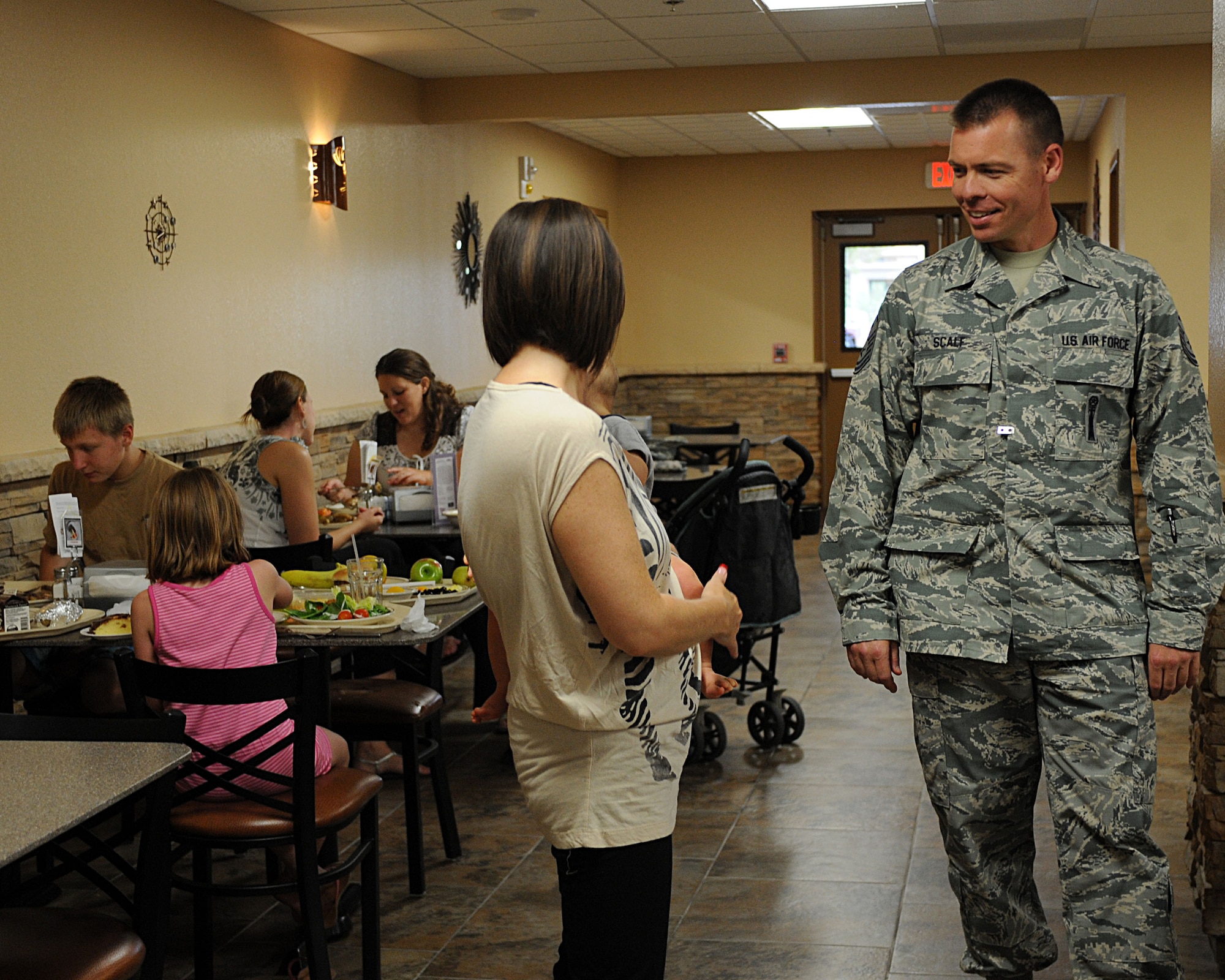 U.S. Air Force Master Sgt. Jeremy Scalf, 612th Air Communications Squadron first sergeant, speaks with Tanya Atkinson, 612th ACOMS key spouse, during the Deployed Spouses’ Dinner at Davis-Monthan Air Force Base, Ariz., July 10, 2013. Key spouses participate in the dinner to help the spouses of deployed Airmen. (U.S. Air Force photo by Senior Airman Timothy Moore/Released)
