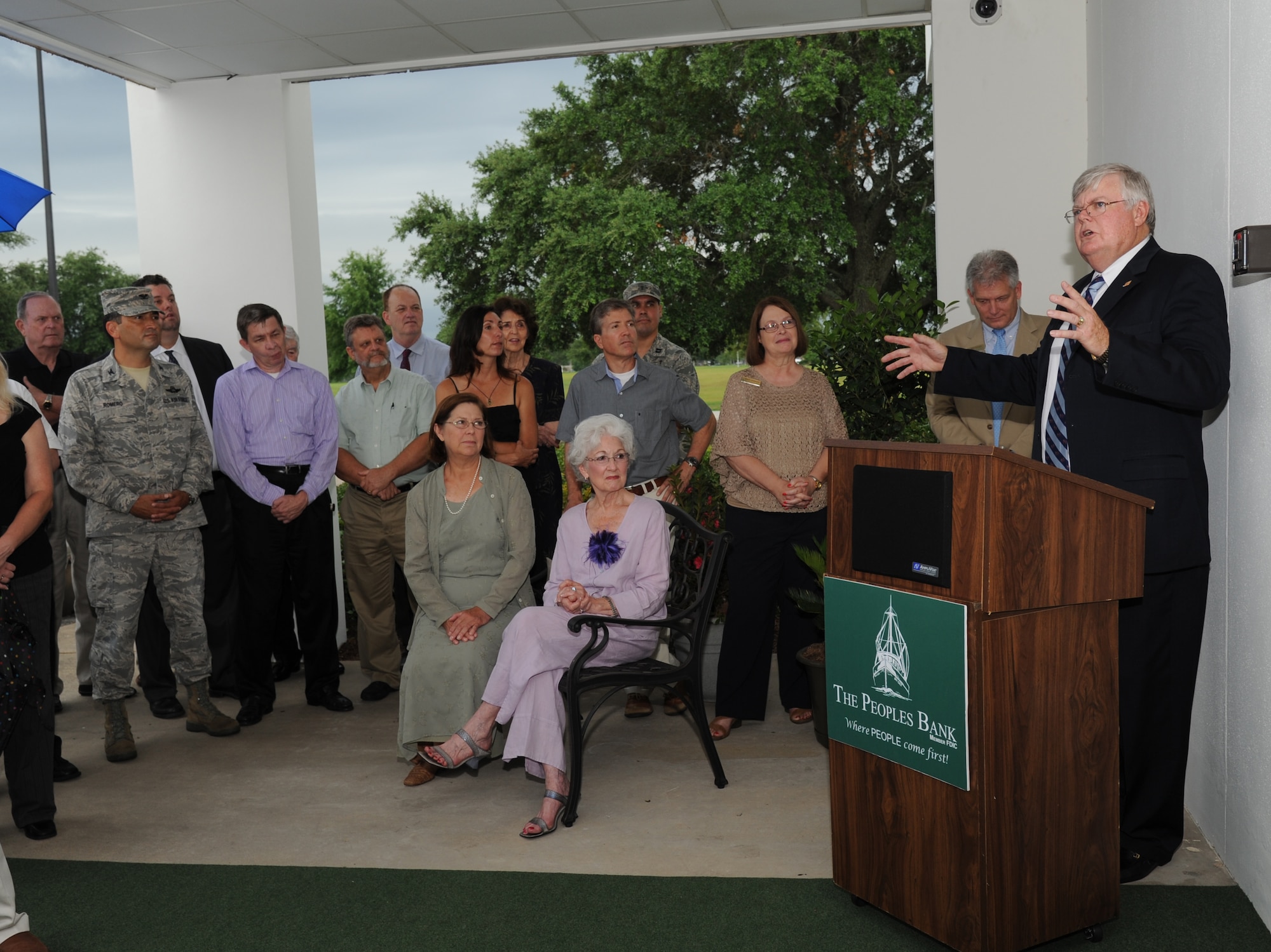 Chevis Swetman, (right),The Peoples Bank president, delivers remarks during The Peoples Bank ribbon cutting ceremony July 11, 2013, Keesler Air Force Base, Miss.  The new branch is located on Meadow Drive next to the Express.  (U.S. Air Force photo by Kemberly Groue)