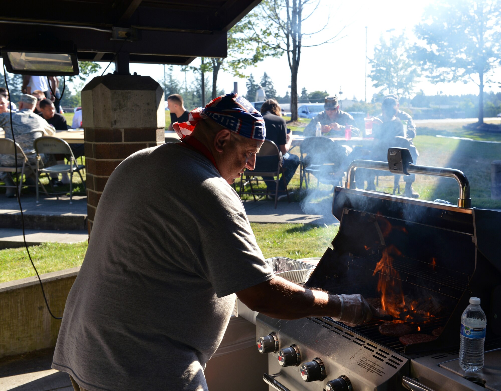 Victor Kemp, USO volunteer, grills hamburgers for Team McChord Airmen during the USO “No Dough” dinner July 10, 2013 at Joint Base Lewis-McChord, Wash. The USO provided dinner, desert and live music for single Airmen to thank them for their service. (U.S. Air Force photo/Staff Sgt. Jason Truskowski)