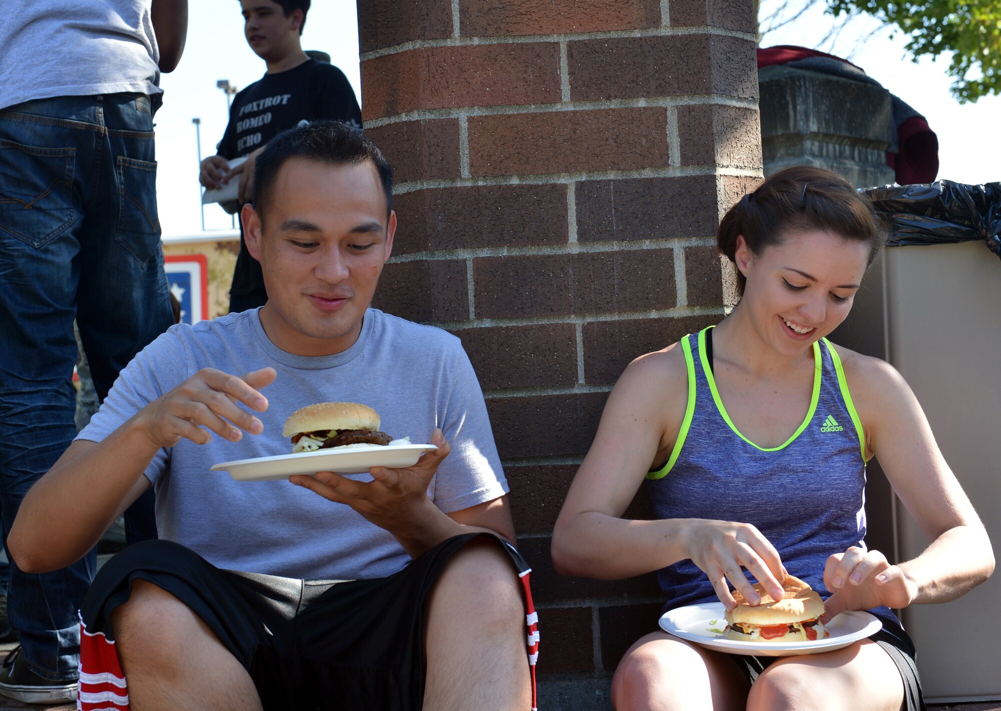 Airmen 1st Class Russel DeLeon and Brittany Kieffer, 62nd Aerial Port Squadron, socialize during the USO “No Dough” dinner July 10, 2013 at Joint Base Lewis-McChord, Wash. The USO hosts the dinner quarterly for Team McChord. (U.S. Air Force photo/Staff Sgt. Jason Truskowski)