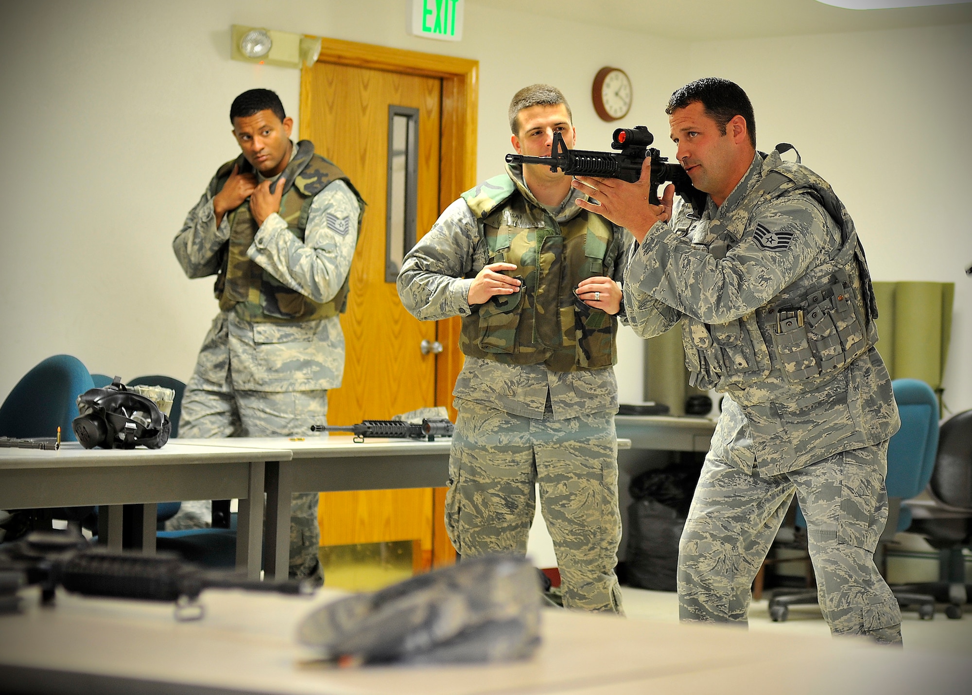 U.S. Air Force Staff Sgt. Greg Chmielewski, 354th Security Forces Squadron combat arms instructor, demonstrates a shooting stance at the Combat Arms Training Range July 9, 2013, Eielson Air Force Base, Alaska. After completing classroom training, Airmen have the opportunity to hone their shooting skills using an engagement skills trainer. (U.S. Air Force photo by Senior Airman Shawn Nickel/Released)