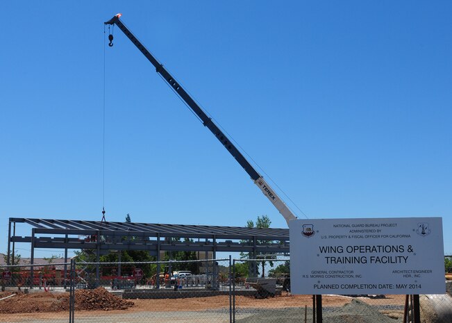 Contractors work on the new Wing Operations & Training Facility for the 162nd Combat Communications Group at Beale Air Force Base, Calif., July 9, 2013. The 10,800-square foot single story building is scheduled to be completed in May 2014. (U.S. Air Force photo by Senior Airman Allen Pollard/Released)