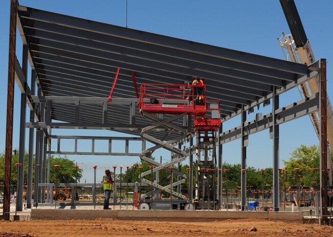 Contractors work on the new Wing Operations & Training Facility for the 162nd Combat Communications Group at Beale Air Force Base, Calif., July 9, 2013. The group has three primary missions: space communications, intelligence, surveillance and reconnaissance, and cyberspace communication service. (U.S. Air Force photo by Senior Airman Allen Pollard/Released)