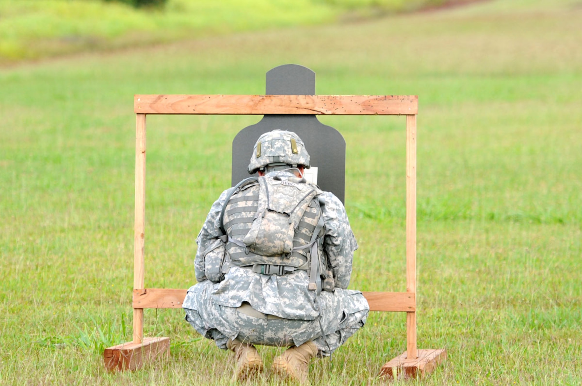 The U.S. Army Pacific’s 2013 Best Warrior Competition winner in the noncommissioned officer category, Army Staff Sgt. De Gosh Reed with the 1st Squadron (Airborne), 40th Cavalry Regiment, checks his target as he competes in the M-16 Zero and Qualification portion of the challenge June 12 at Schofield Barracks, Hawaii. (Photo courtesy of USARPAC Public Affairs)