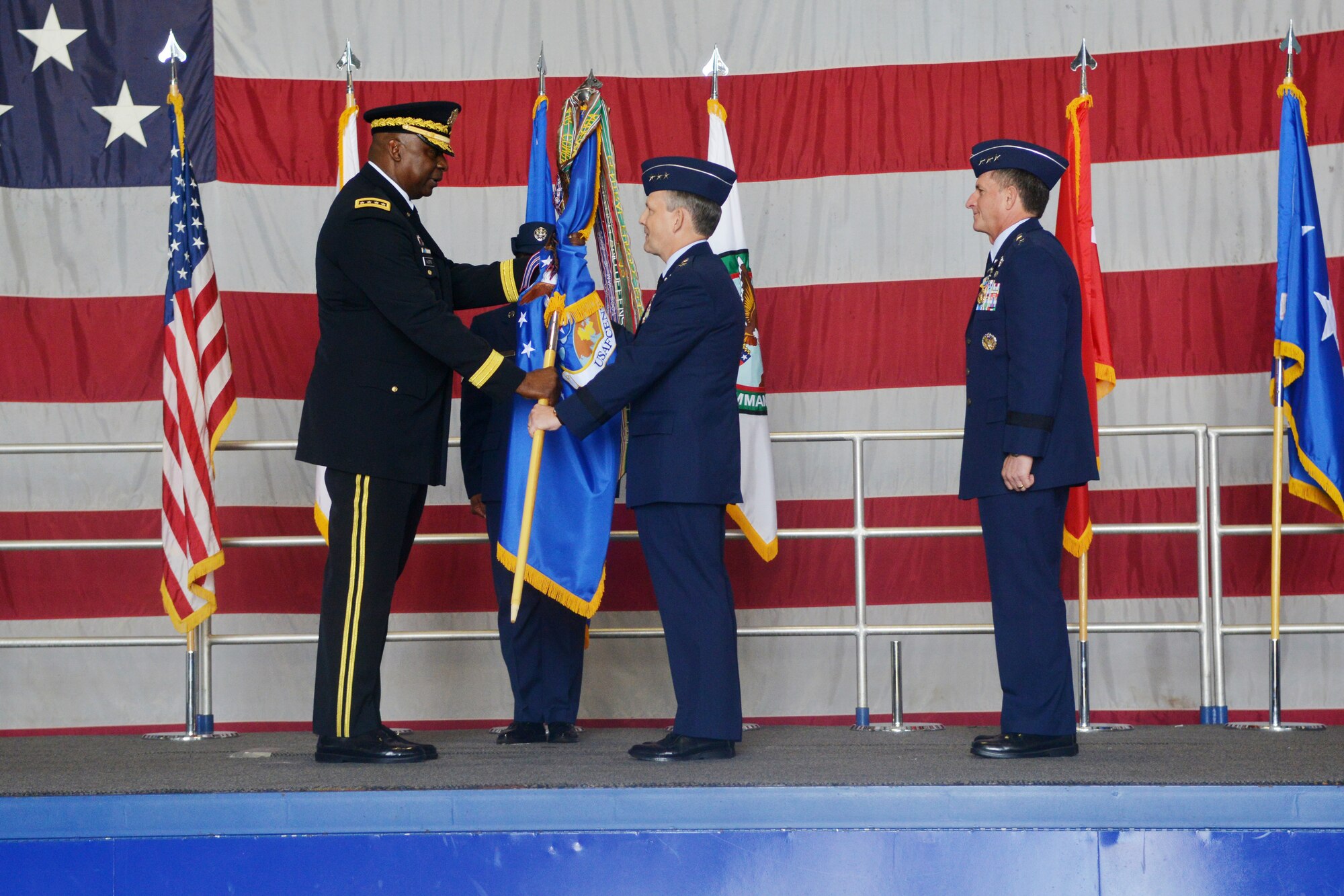 The U.S. Air Forces Central Command guide-on is passed to Lt. Gen. John W. Hesterman III by presiding officer U.S. Army Gen. Lloyd J. Austin, commander U.S. Central Command, during a change of command ceremony, Shaw Air Force Base, S.C., July 11, 2013. Changes of command are a military tradition representing the transfer of responsibilities from the presiding officials to the upcoming official. Approximately 1,000 service members, civil servants, community leaders, and their families, attended the hour-long event.  (U.S. Air Force photo by Airman 1st Class Ashley L. Gardner/Released)
