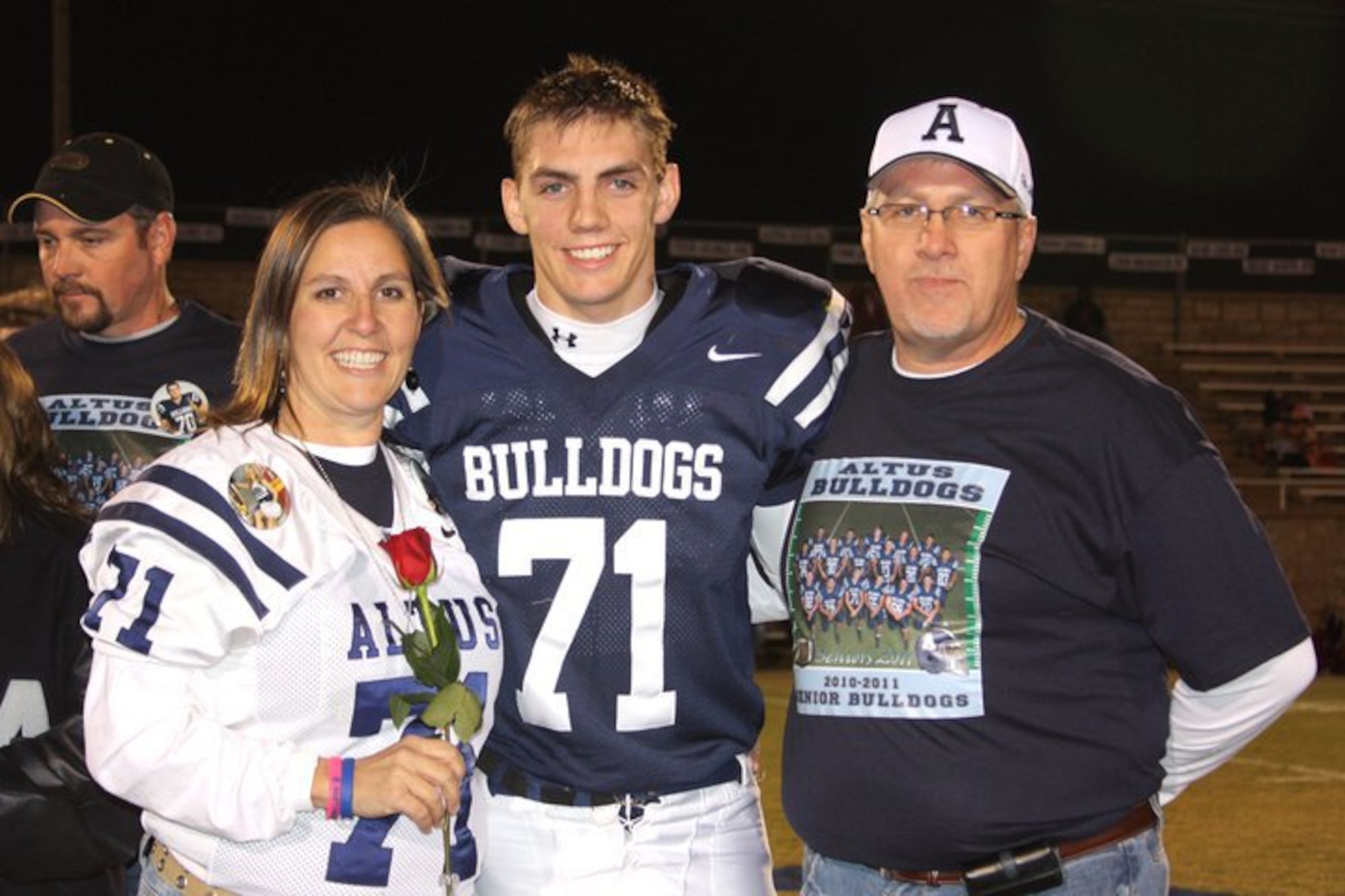 ALTUS AIR FORCE BASE, Okla. – Jeremy Delzer poses for a photo with his parents, Jaretta and Scott Delzer, at the Altus High School football stadium November 16, 2010. Since graduating in 2011, Delzer has joined the U.S. Air Force Academy with plans to commission and pursue a career as a pilot or an Intelligence officer. (Courtesy photo) 