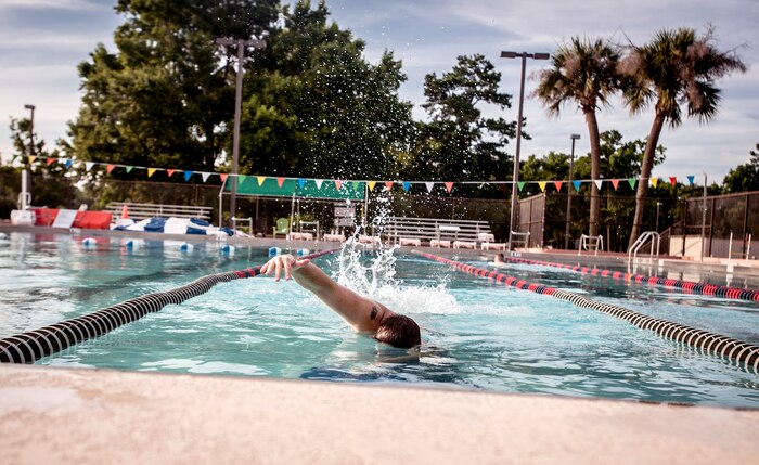 Senior Airman Brandon Couch, 628th Air Base Wing Comptroller Squadron customer service technician, swims laps July 10, 2013, in pool at Joint Base Charleston – Air Base, S.C. Couch was participating  in the physical training program offered at the pool during the summer months, and although he is on a medical profile, the trained instructors were able to find specific workouts that allowed him to maintain his fitness level while not aggravating his injuries. . (U.S. Air Force photo / Airman 1st Class Tom Brading) 