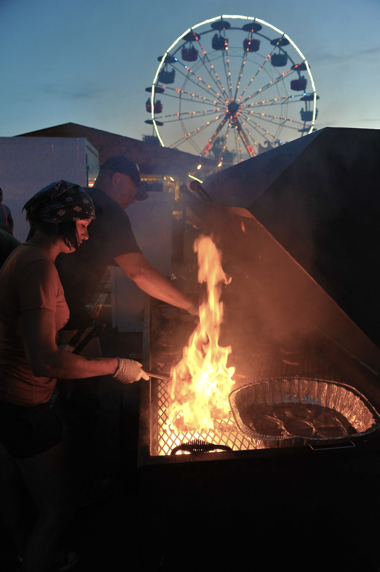 Members of the KMC cook during the ‘Rockin 4th of July’ festival held to celebrate the independence of the United States of America, July 4, 2013, Ramstein Air Base, Germany. America declared its independence from Britain on July 4, 1776, now considered the birth day of the United States of America. 237 years later it is still celebrated remember the day of declared independence. Ramstein celebrated with festivities to included; live music, children’s activities, carnival rides, food specialties and a fireworks show. (U.S. Air Force photo/Airman Dymekre Allen)