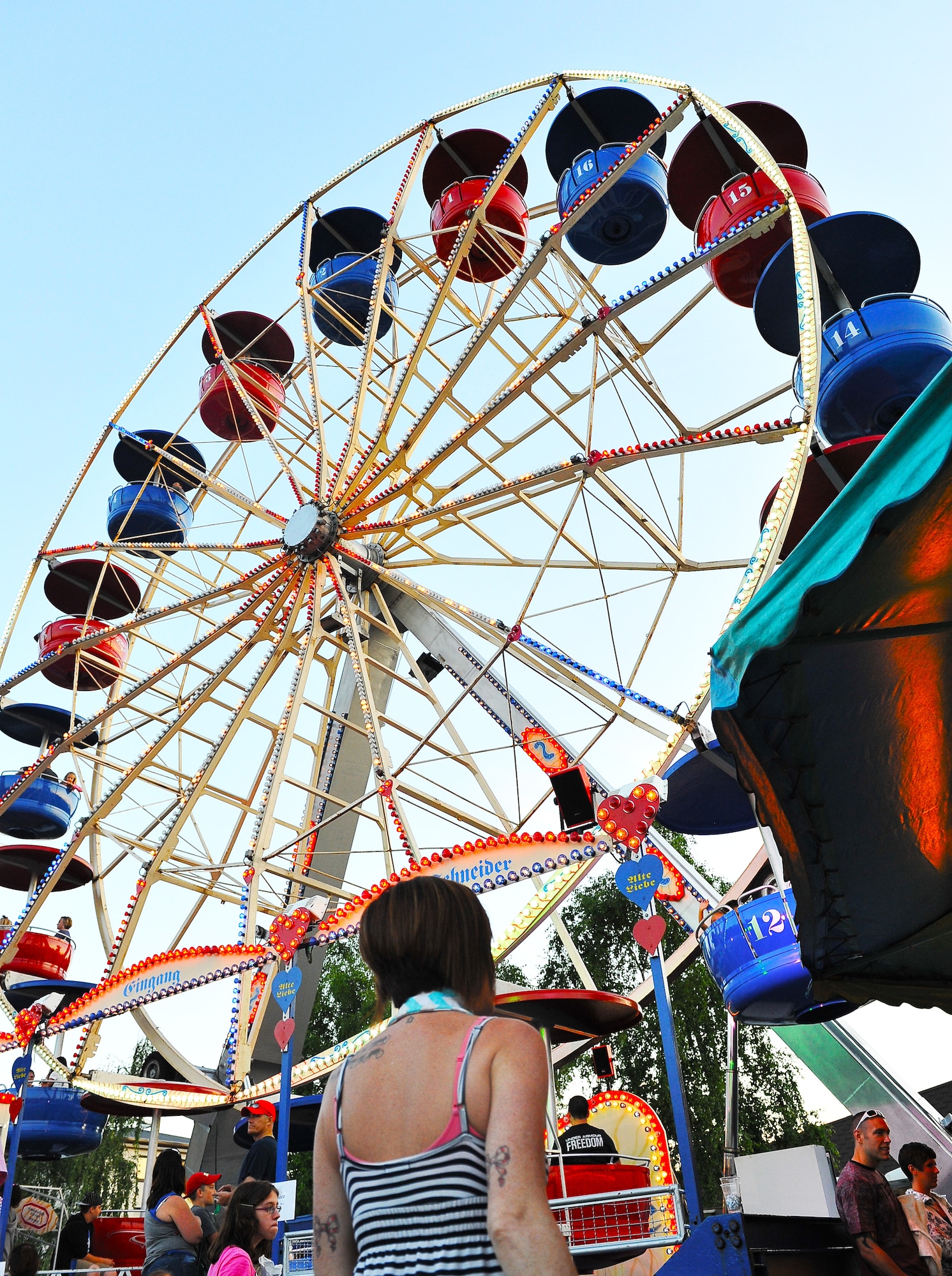 ‘Rockin 4th of July’ attendees wait to ride the Ferris wheel during the festival held to celebrate the independence of the United States of America, July 4, 2013, Ramstein Air Base, Germany.. America declared its independence from Britain on July 4, 1776, now considered the birth day of the United States of America. 237 years later it is still celebrated remember the day of declared independence. Ramstein celebrated with festivities to included; live music, children’s activities, carnival rides, food specialties and a fireworks show. (U.S. Air Force photo/Airman Dymekre Allen)
