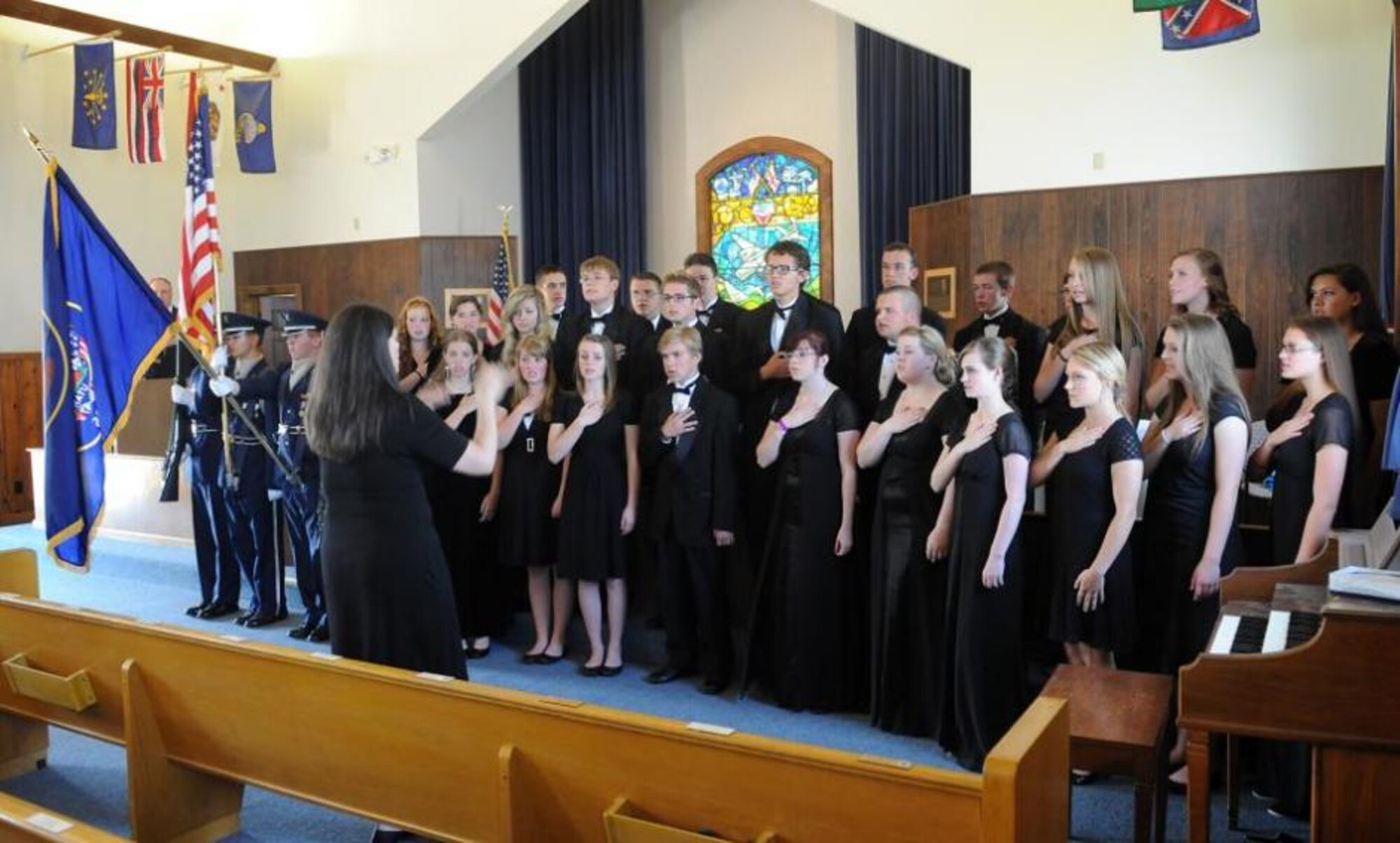 The Clearfield High School Madrigal Choir sings the Star Spangled Banner as the colors are displayed by the Air Force Junior Reserve Officers Corps from Clearfield High School as part of the Let Freedom Ring national bell ringing event at the Nate Mazer Memorial Chapel at the Hill Aerospace Museum on July 4. (U.S. Air Force photo by Alex R. Lloyd/Released)