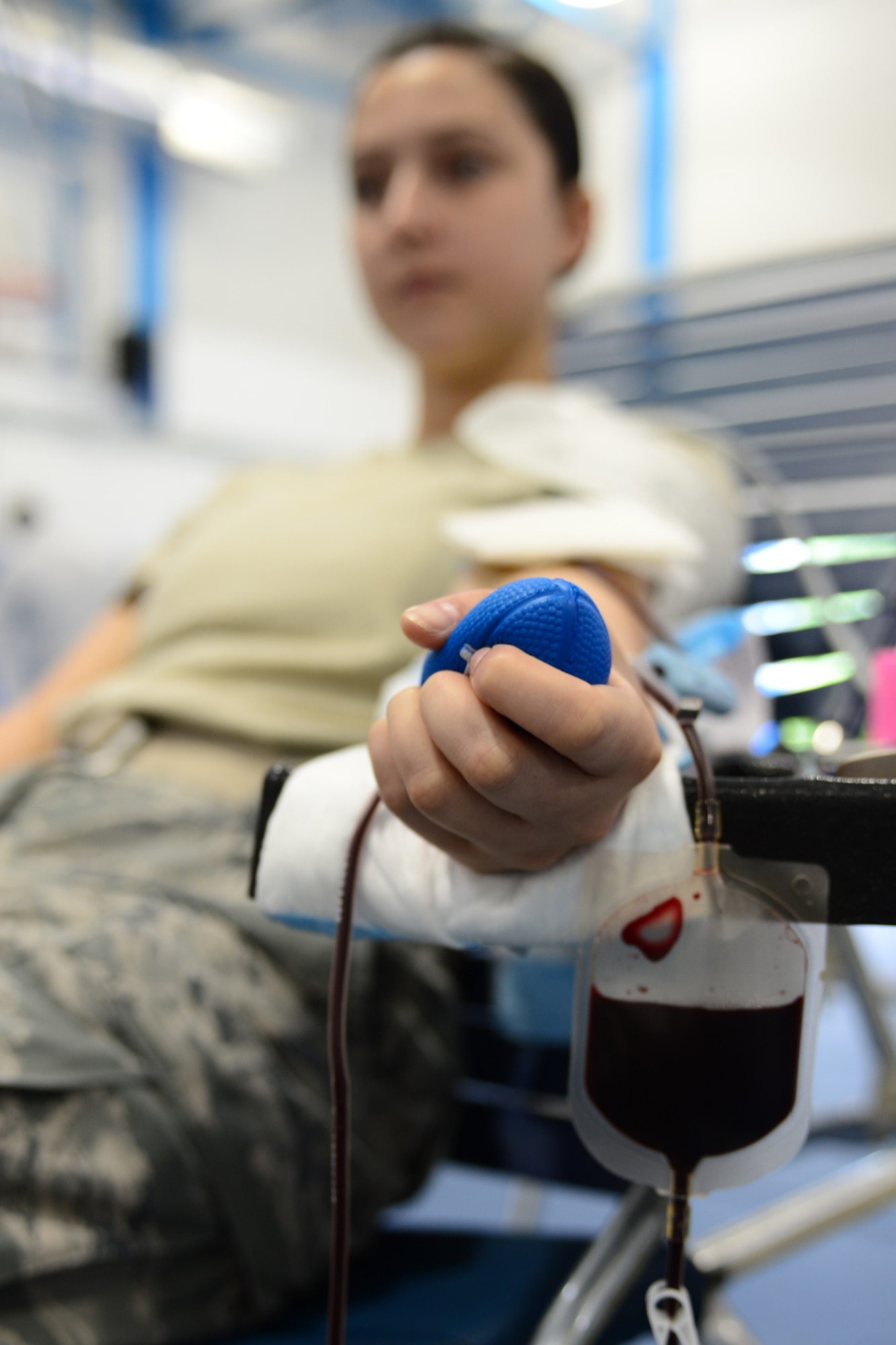ROYAL AIR FORCE LAKENHEATH, England – Senior Airman Kiirstyn Williams, 48th Security Forces Squadron NCO in charge of reports and analyses, squeezes a stress ball to keep circulation in her arm while donating blood July 10, 2013. Personnel from Landstuhl Regional Medical Center’s Armed Services Blood Program in Germany came to RAF Lakenheath and RAF Mildenhall to conduct blood drives. The ASBP only collects blood from the military community, which includes service members, family members, retirees and Department of Defense civilians, and all blood collected stays in the military community. (U.S. Air Force photo by Airman 1st Class Dana J. Butler) 