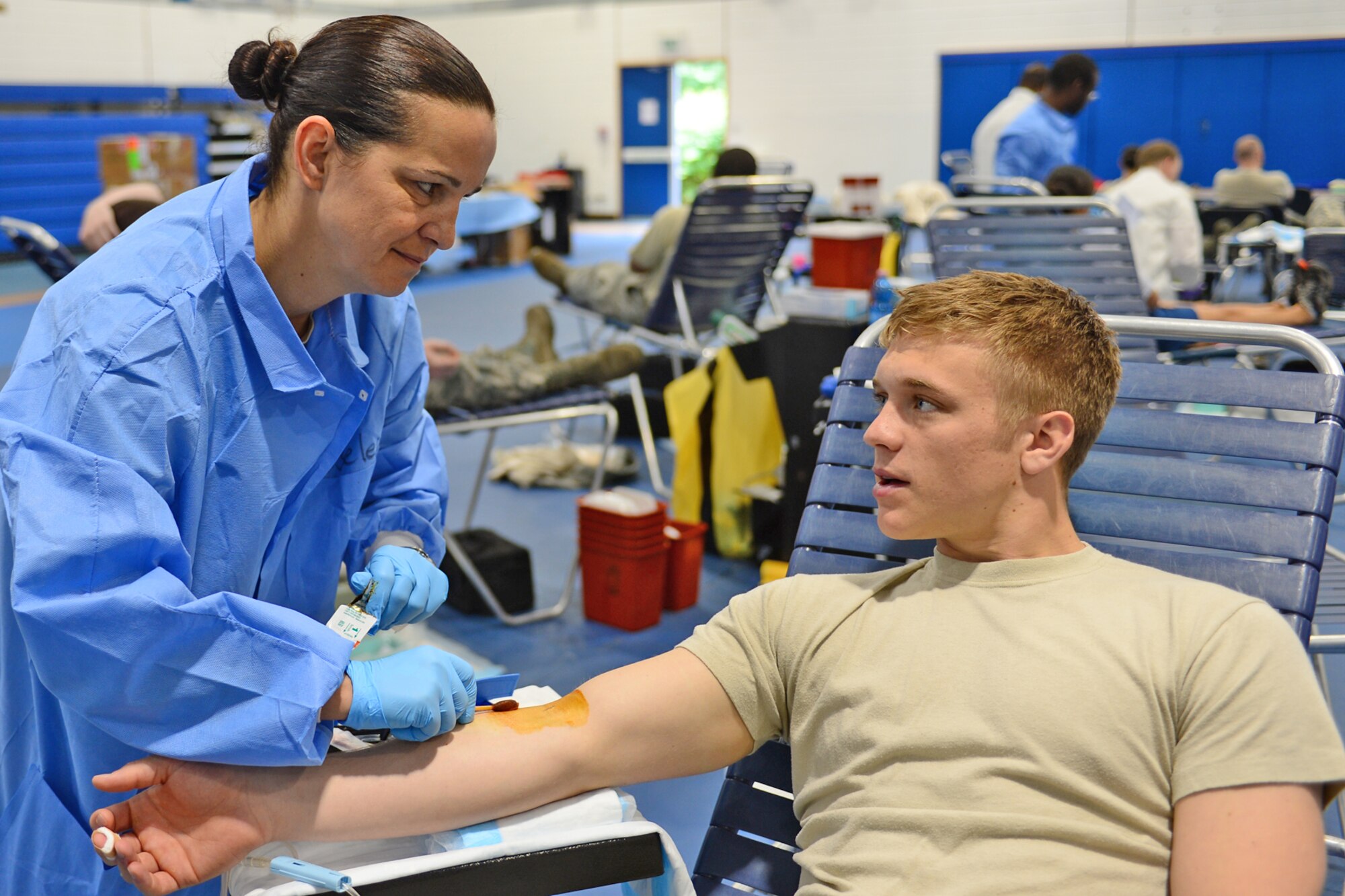 ROYAL AIR FORCE LAKENHEATH, England – Master Sgt. Sabrina Moseley, Landstuhl Regional Medical Center NCO in charge of the Armed Services Blood Program, Germany, prepares to draw blood from Airman 1st Class Tyler Wineman, 56th Rescue Squadron aircrew flight equipment apprentice, during the ASBP Blood Drive July 10, 2013. The ASBP only collects blood from the military community, which includes service members, family members, retirees and Department of Defense civilians, and all blood collected stays in the military community. (U.S. Air Force photo by Airman 1st Class Dana J. Butler) 