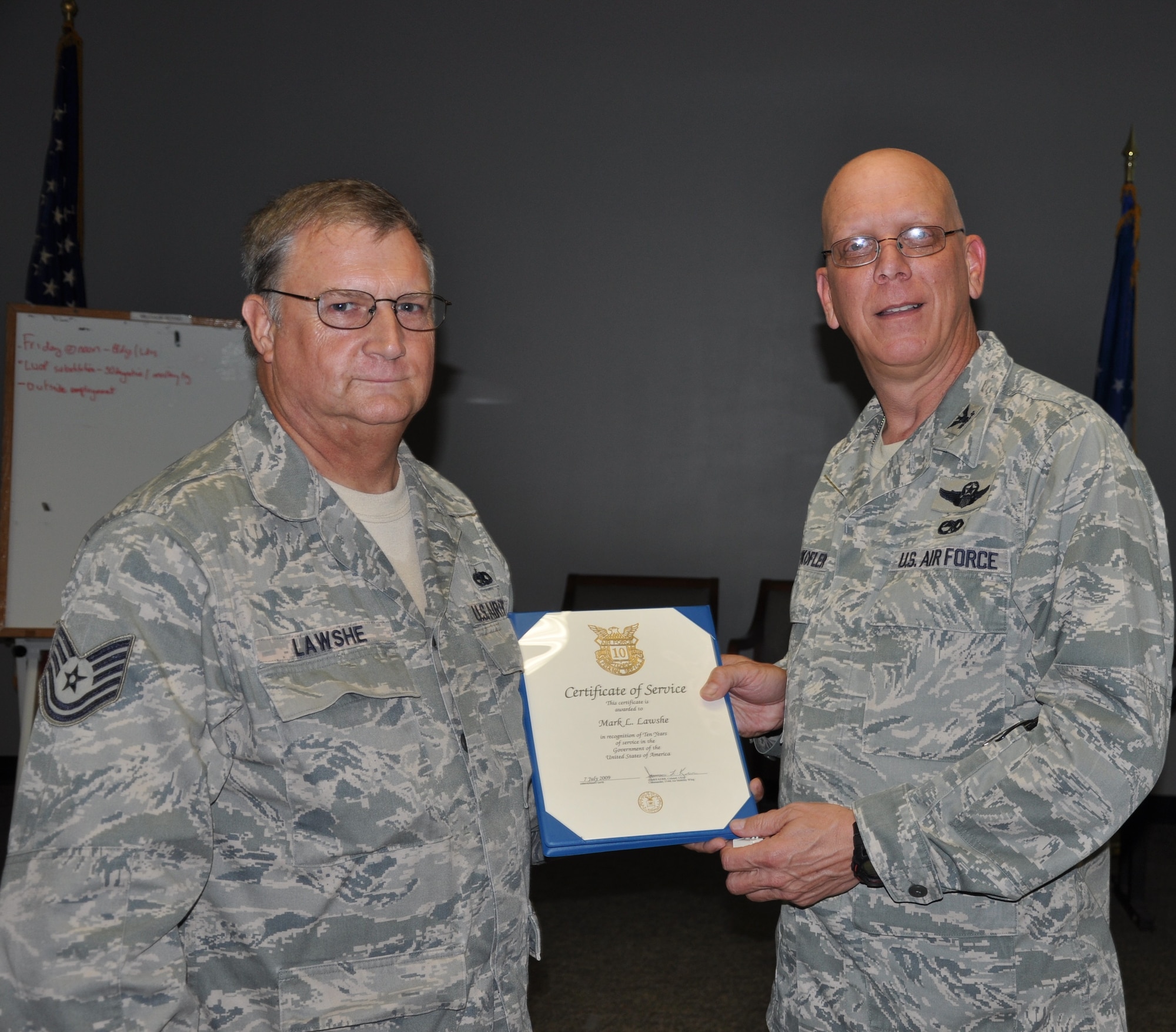Tech. Sgt. Mark Lawshe, 514th Aircraft Maintenance Squadron, receives the 10 Year Certificate of Service award from Col. Michael J. Underkofler, 514th Air Mobility Wing commander, during a civilian commander’s call held here July 2. (U.S. Air Force photo by Tech. Sgt. Jonathan E. White)