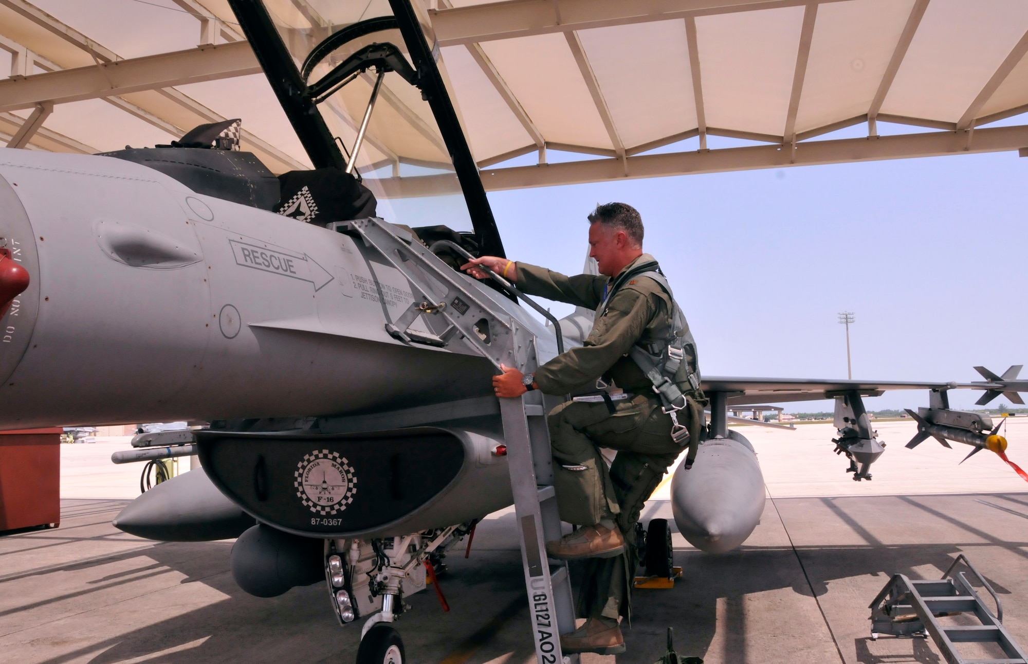 Maj. Robin Lytle, 93rd Fighter Squadron F-16 pilot and chief of scheduling, climbs into the cockpit of an F-16 at Homestead Air Reserve Base, Fla., May 9. Lytle began his career as a weapons loader at Bergstrom Air Force Base, Texas, in 1989. (U.S. Air Force photo/Senior Airman Jaimi Upthegrove)