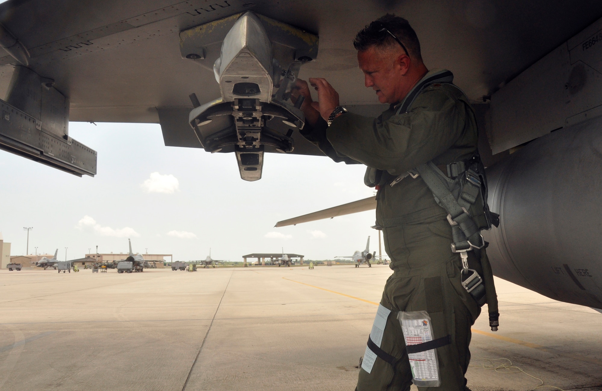 Maj. Robin Lytle, 93rd Fighter Squadron F-16 pilot and chief of scheduling, performs a pre-flight inspection on an F-16 at Homestead Air Reserve Base, Fla., May 9. Lytle began his career as a weapons loader at Bergstrom Air Force Base, Texas, in 1989. (U.S. Air Force photo/Senior Airman Jaimi Upthegrove)