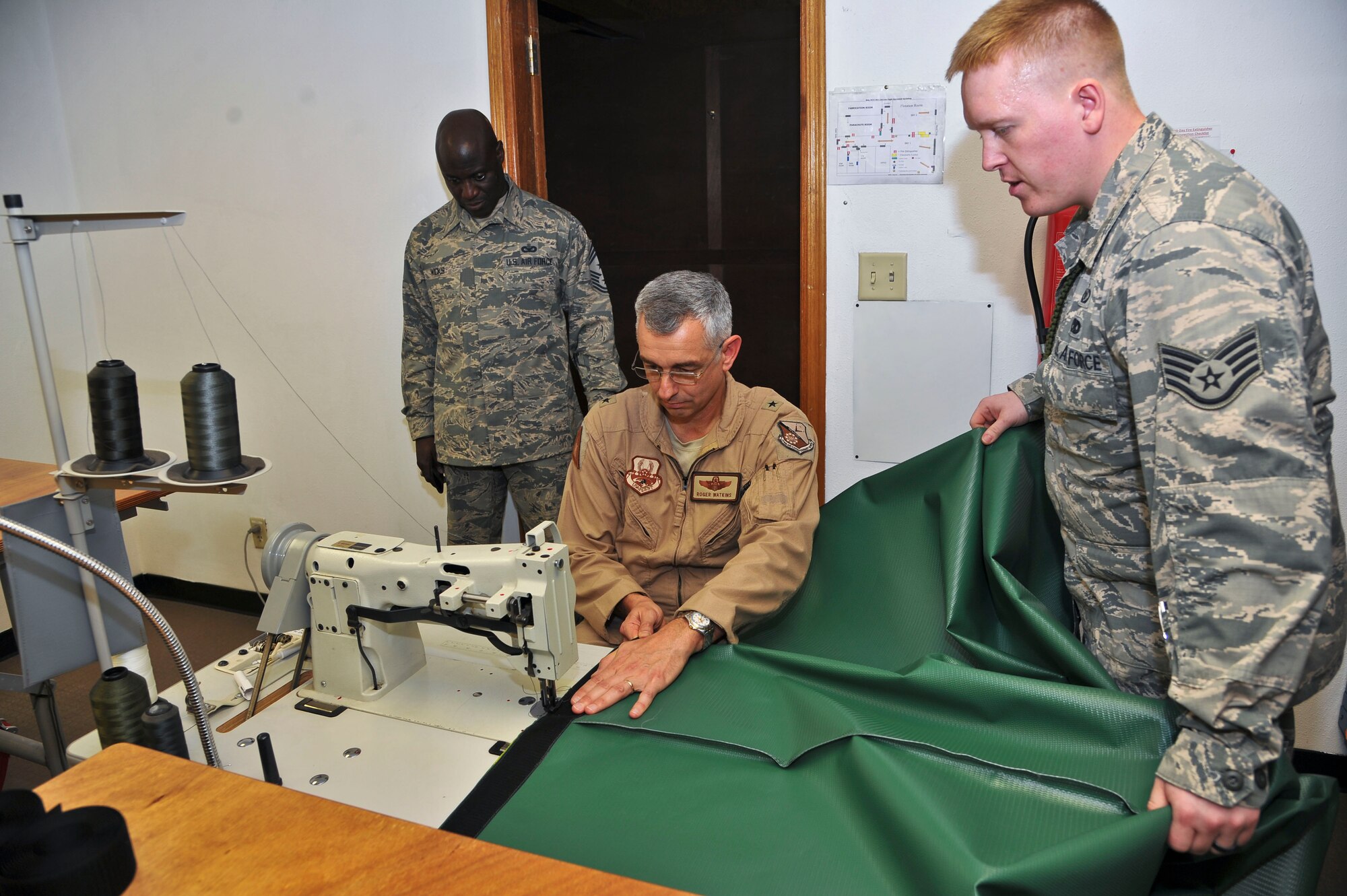 Brig. Gen. Roger Watkins sews together a piece of a B-1B Lancer Rotary Bomb Module Cover during the general’s visit to the 379th Expeditionary Operations Support Squadron at the 379th Air Expeditionary Wing in Southwest Asia, July 5, 2013. The 379th EOSS Aircrew Flight Equipment is the sole parachute back shop in the U.S. Central Command’s area of responsibility, supporting 11 other bases and is the primary inspector for equipment down range. Watkins is the 379th AEW commander. (U.S. Air Force photo/Tech. Sgt. Joselito Aribuabo)