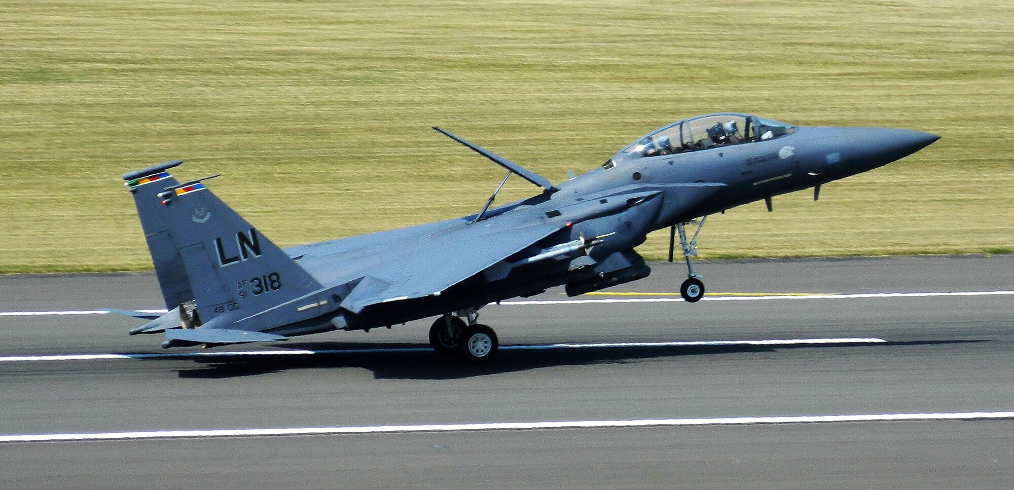 ROYAL AIR FORCE LAKENHEATH, England – An F-15E Strike Eagle lands on the RAF Lakenheath runway after doing a “fly by” as part of standard training July 9, 2013. The Strike Eagles of the 48th Fighter Wing are dual-role fighters designed to perform air-to-air and air-to-ground missions. (U.S. Air Force photo by Elizabeth Ritsema) 