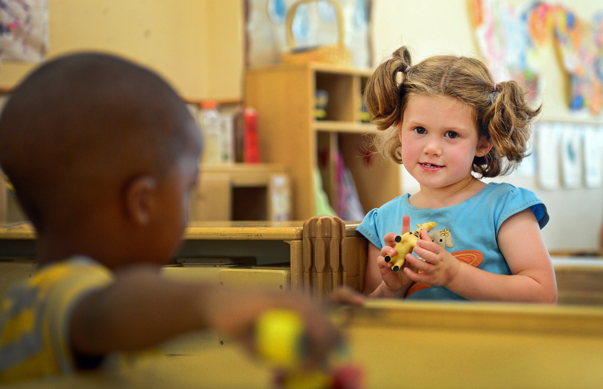 Audrey Allen, daughter of Navy Lt. Christopher Allen, plays with a toy at the Child Development Center, July 11, 2013, at Aviano Air Base, Italy. The CDC’s sublet program allows parents with children enrolled in the CDC to temporarily sublet their child’s spot. (U.S. Air Force photo/Airman 1st Class Matthew Lotz)
