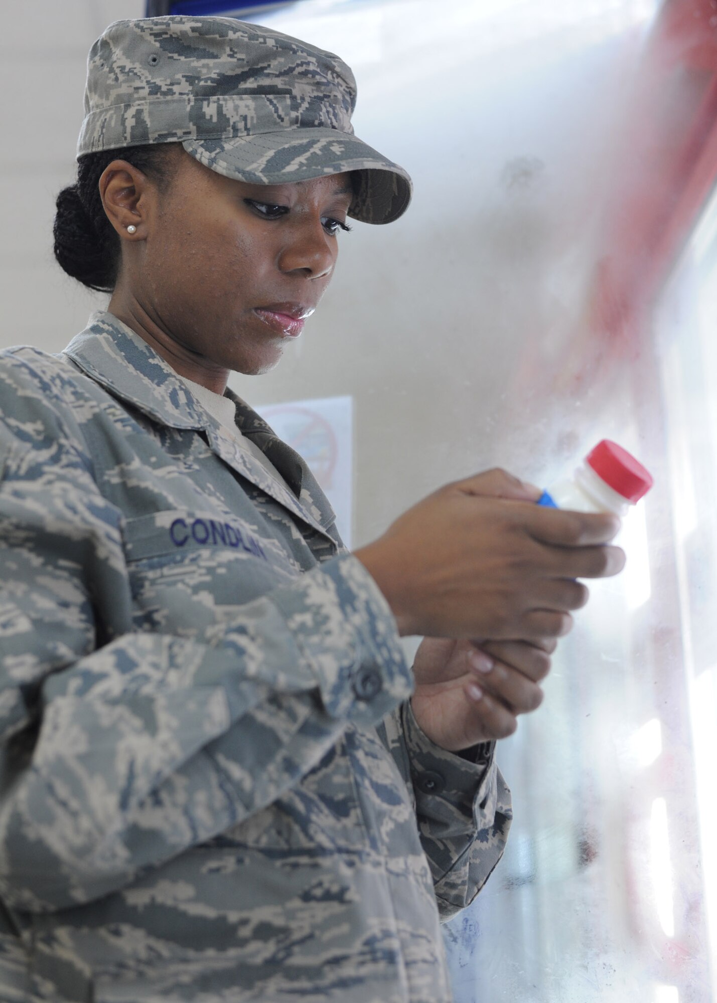 Senior Airman Takecia Condlin checks the expiration date on a milk bottle at the Independence Hall Dining Facility at the 379th Air Expeditionary Wing in Southwest Asia, July 10, 2013. The dining facilities at the 379th AEW support more than 8,000 U.S. and coalition forces. Coldlin is a 379th Expeditionary Force Support Squadron food service journeyman deployed from Pope Army Air Field, N.C. (U.S. Air Force photo/Senior Airman Bahja J. Jones) 