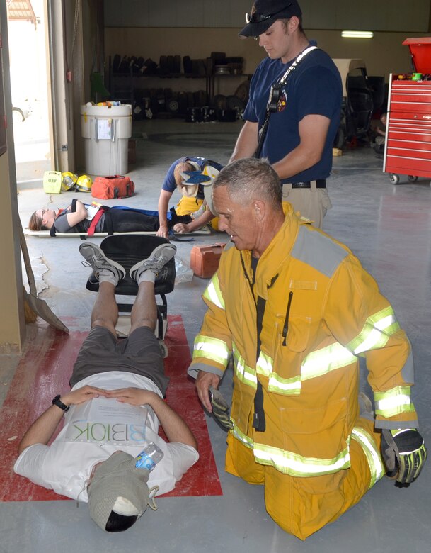 First responders from the 64th Air Expeditionary Group perform Self Aid and Buddy Care on simulated victims during a mass casualty incident and major accident training exercise called Spartan Flex 13-5 at the 64th AEG in Southwest Asia, June 26, 2013. The exercise was designed to test the readiness capabilities of everyone assigned to the 64th AEG. (Courtesy photo)
