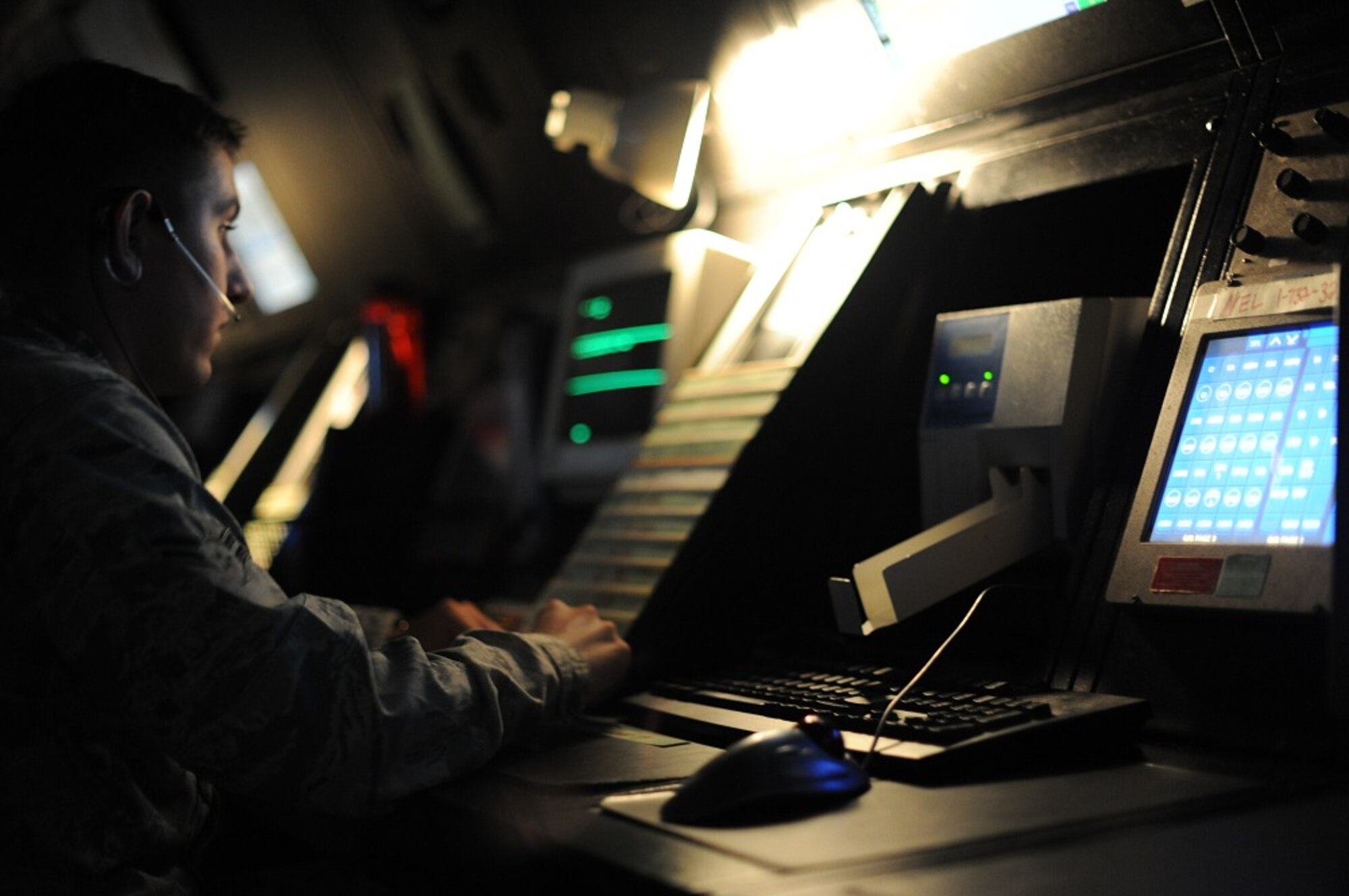 Airman 1st Class Kyle Sapp, 305th Operations Support Squadron Radar Approach Control air traffic control journeyman, reads flight paths to pilots via radio July 9, 2013, at Joint Base McGuire-Dix-Lakehurst, N.J. The RAPCON operates 24/7, 365 days a year to direct all military and civilian aircraft traffic, including fixed-wing and rotary-wing aircraft, from the ground to 8,000-feet altitude. (U.S. Air Force photo by Airman 1st Class Sean M. Crowe/Released)